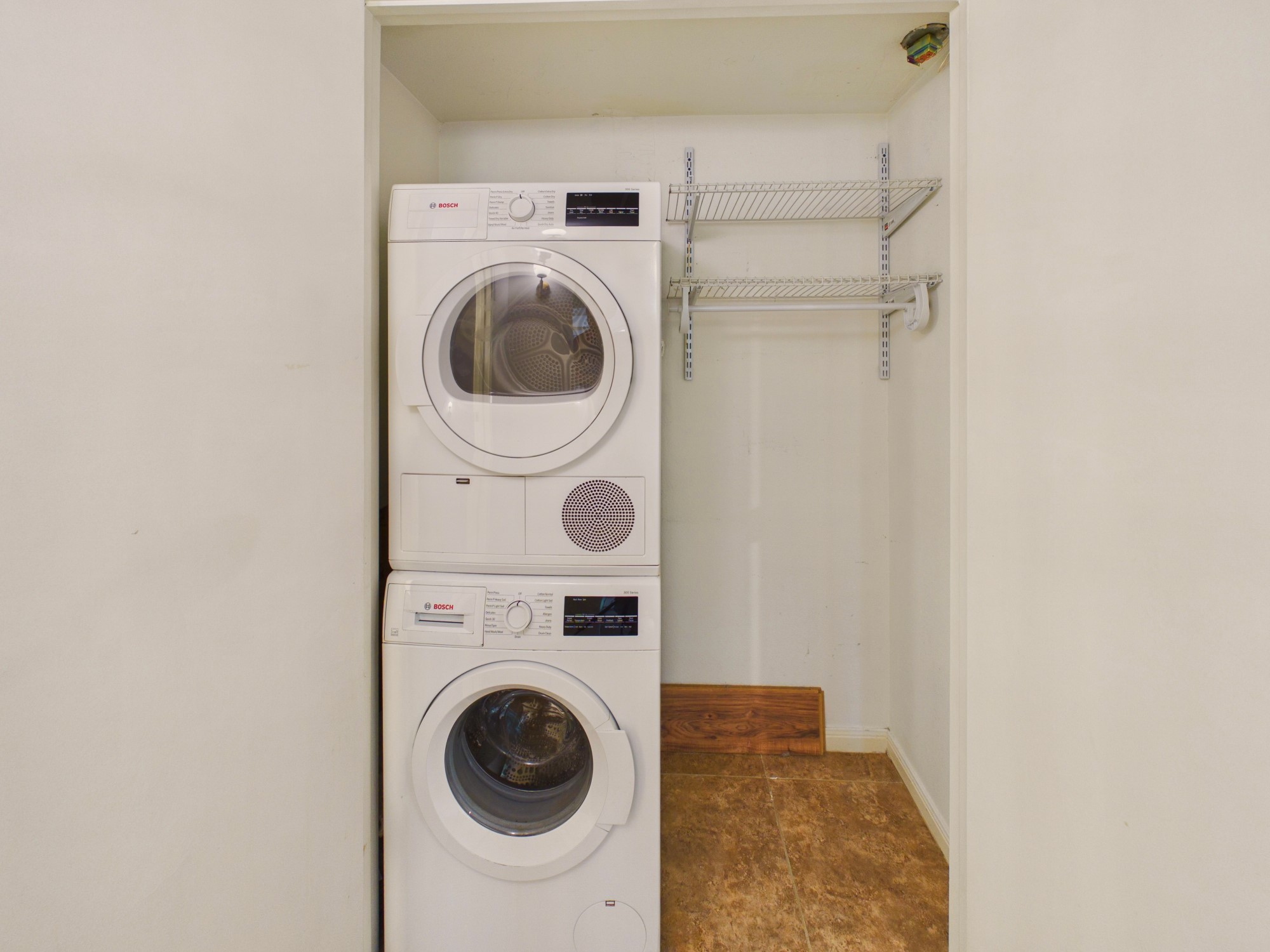 Utility Closet with Full Sized Stacked Washer & Dryer Included