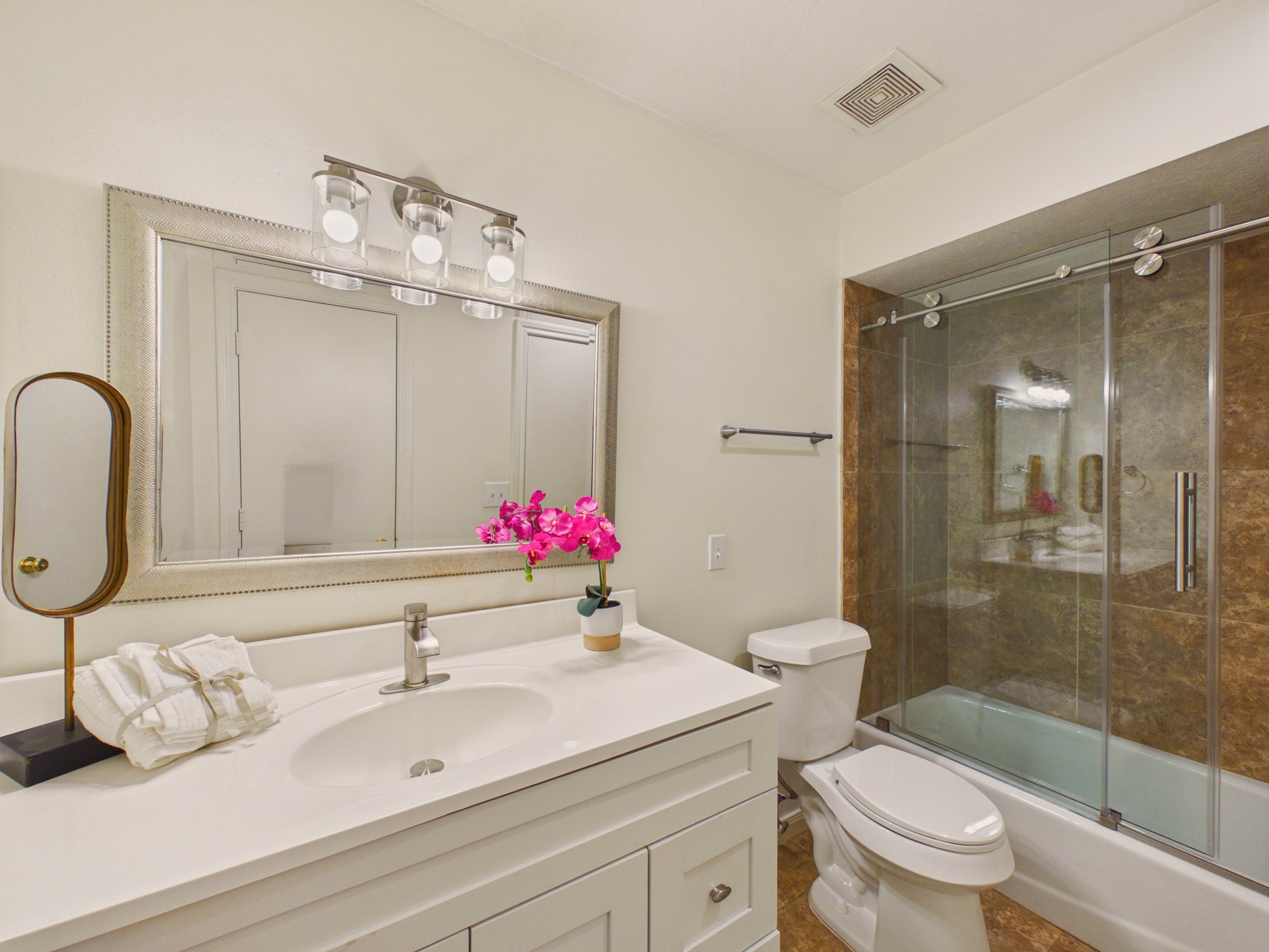 Nicely Appointed Bathroom with Large Vanity and Tub/Shower Combo with Glass Shower Door