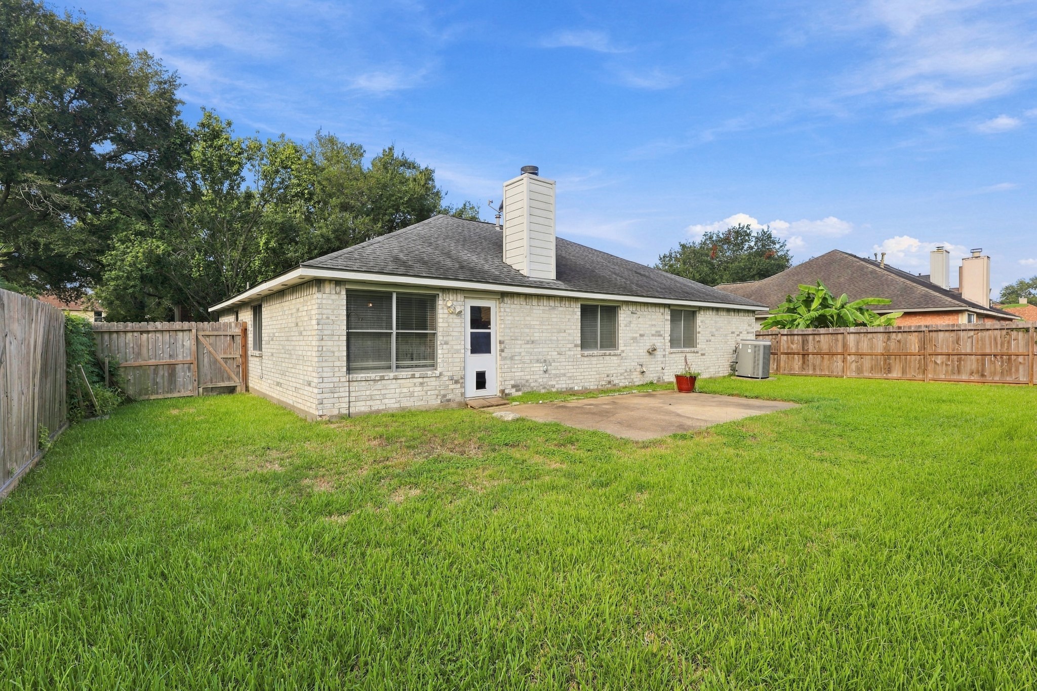 Spacious backyard with patio area ready for grilling, entertaining and relaxing outdoors.