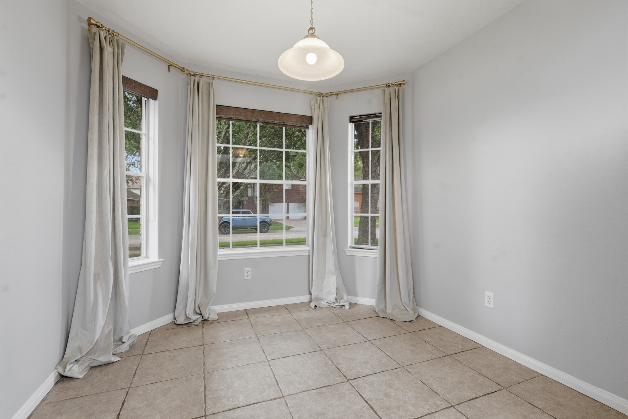 Bright breakfast nook surrounded by windows for a cheerful start to the day.