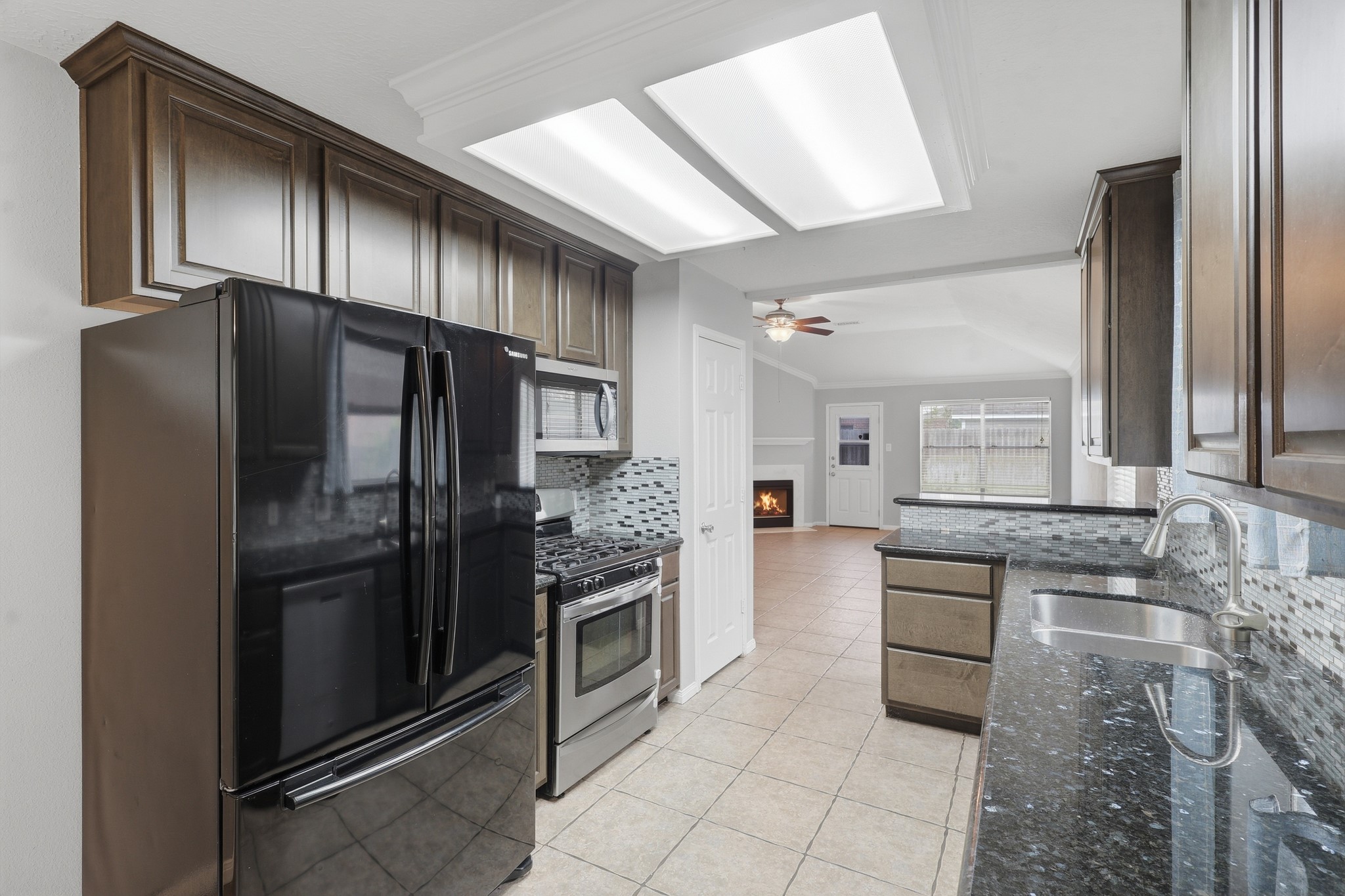 Functional kitchen design with granite counters and convenient access to the dining and breakfast areas.