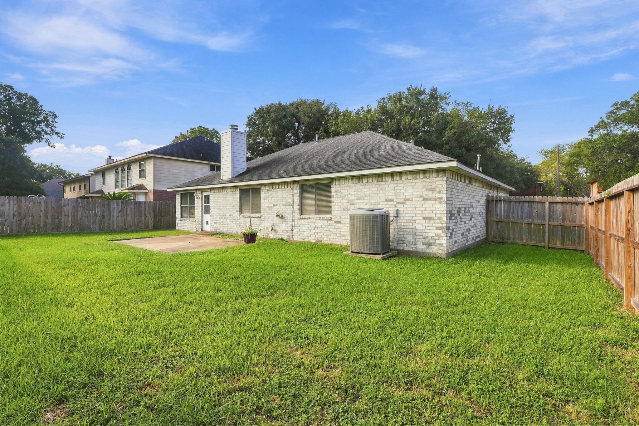 Another view of the generous fenced yard with room to create your own outdoor retreat.