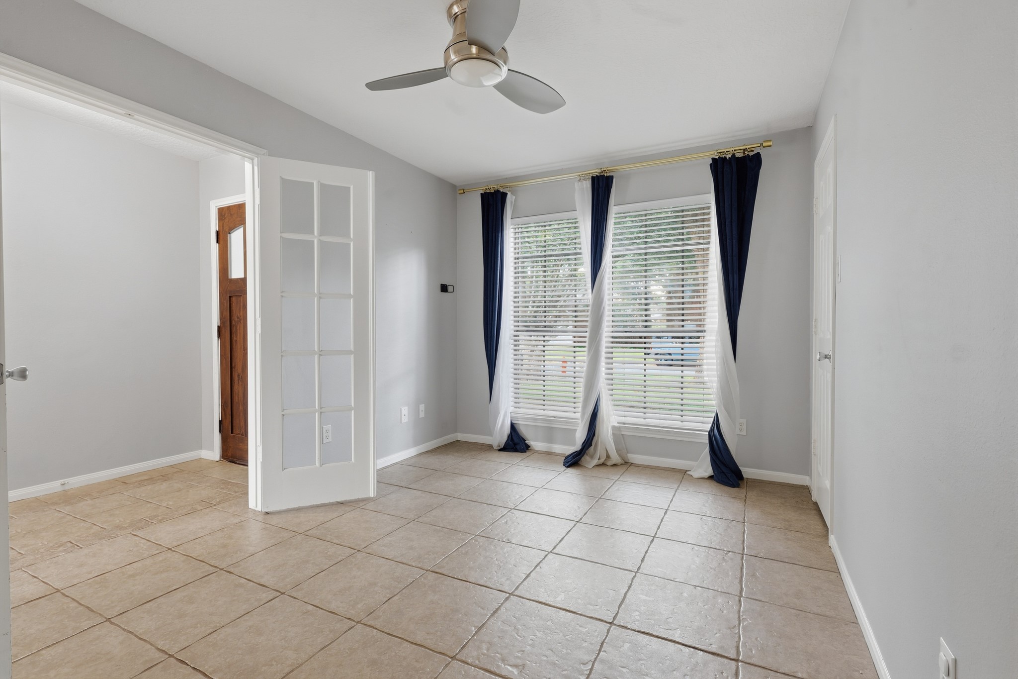 French doors create a stylish entrance to this flexible bedroom or home office.