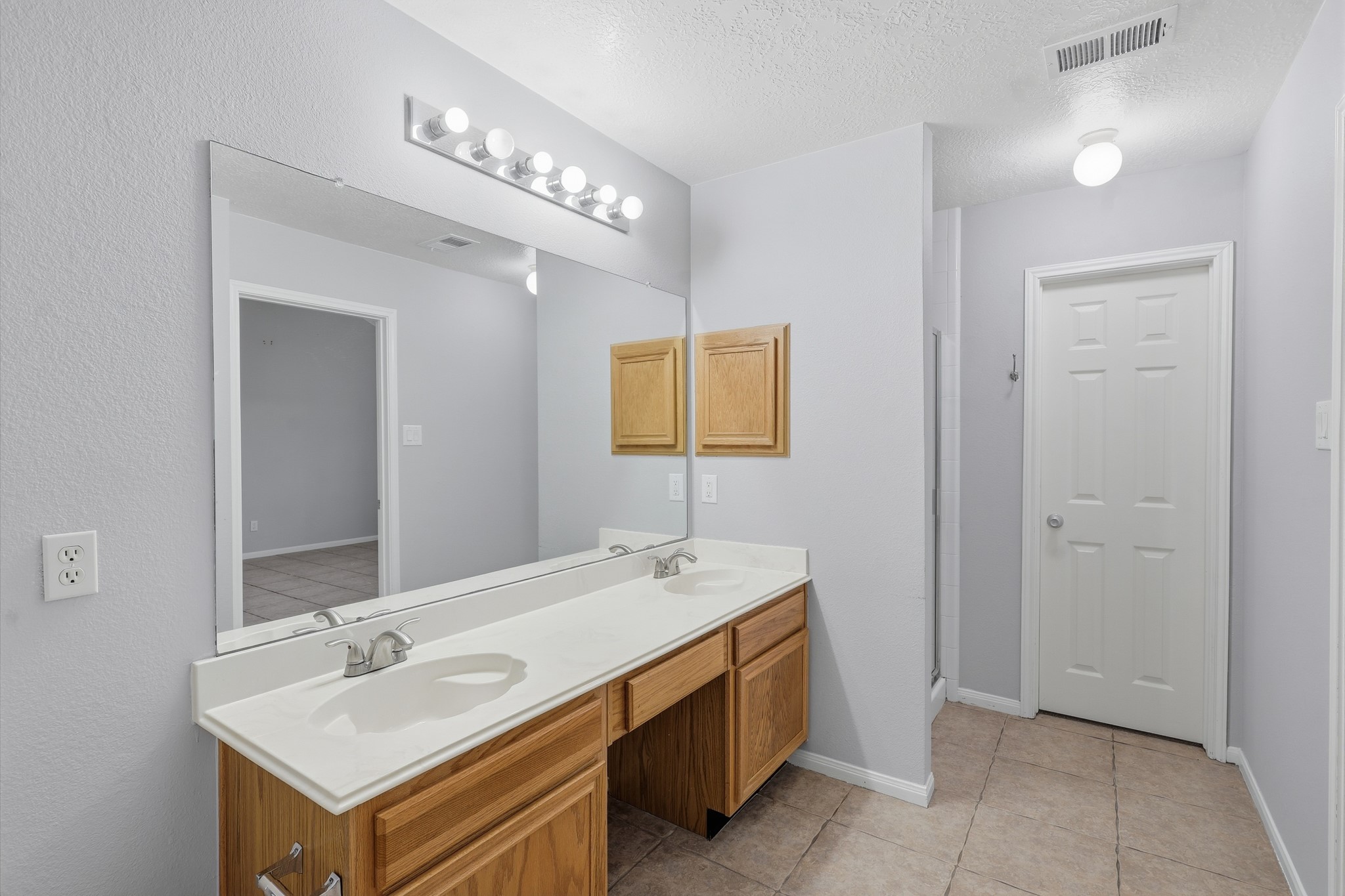 Double sinks and generous vanity space make busy mornings a little easier.
