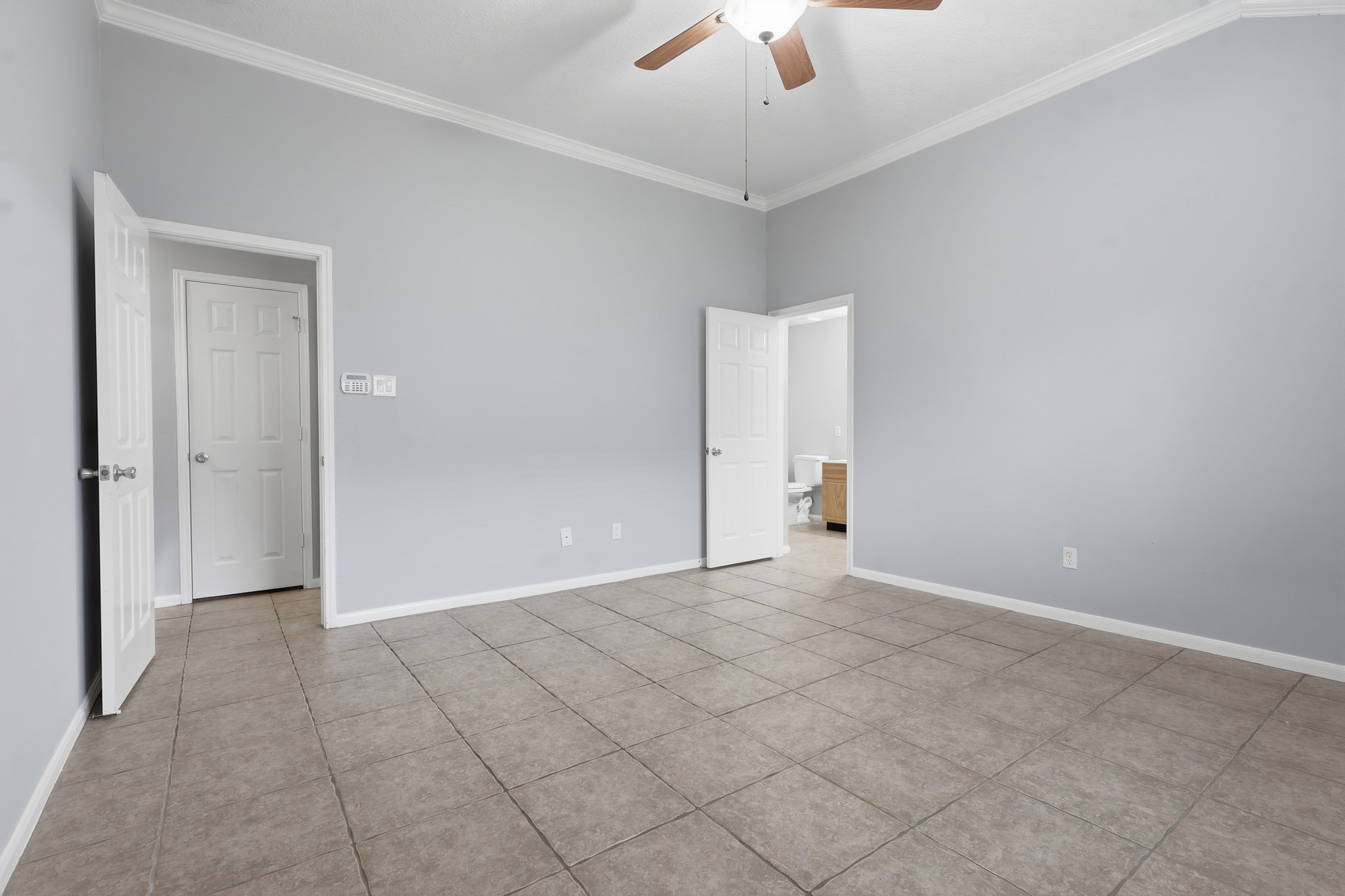 Additional view of the generously sized primary bedroom with neutral finishes.