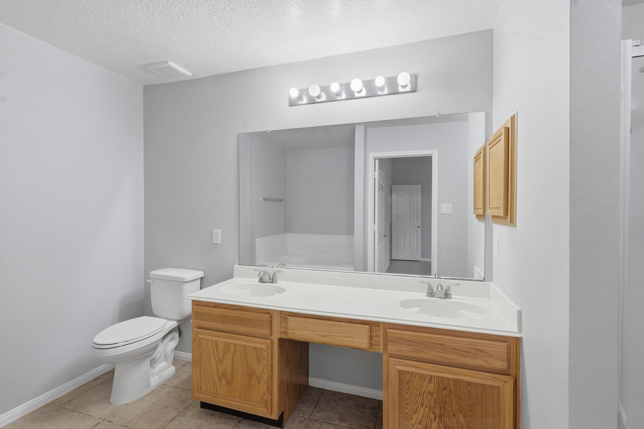 Primary bath features a large double vanity with plenty of counter space.