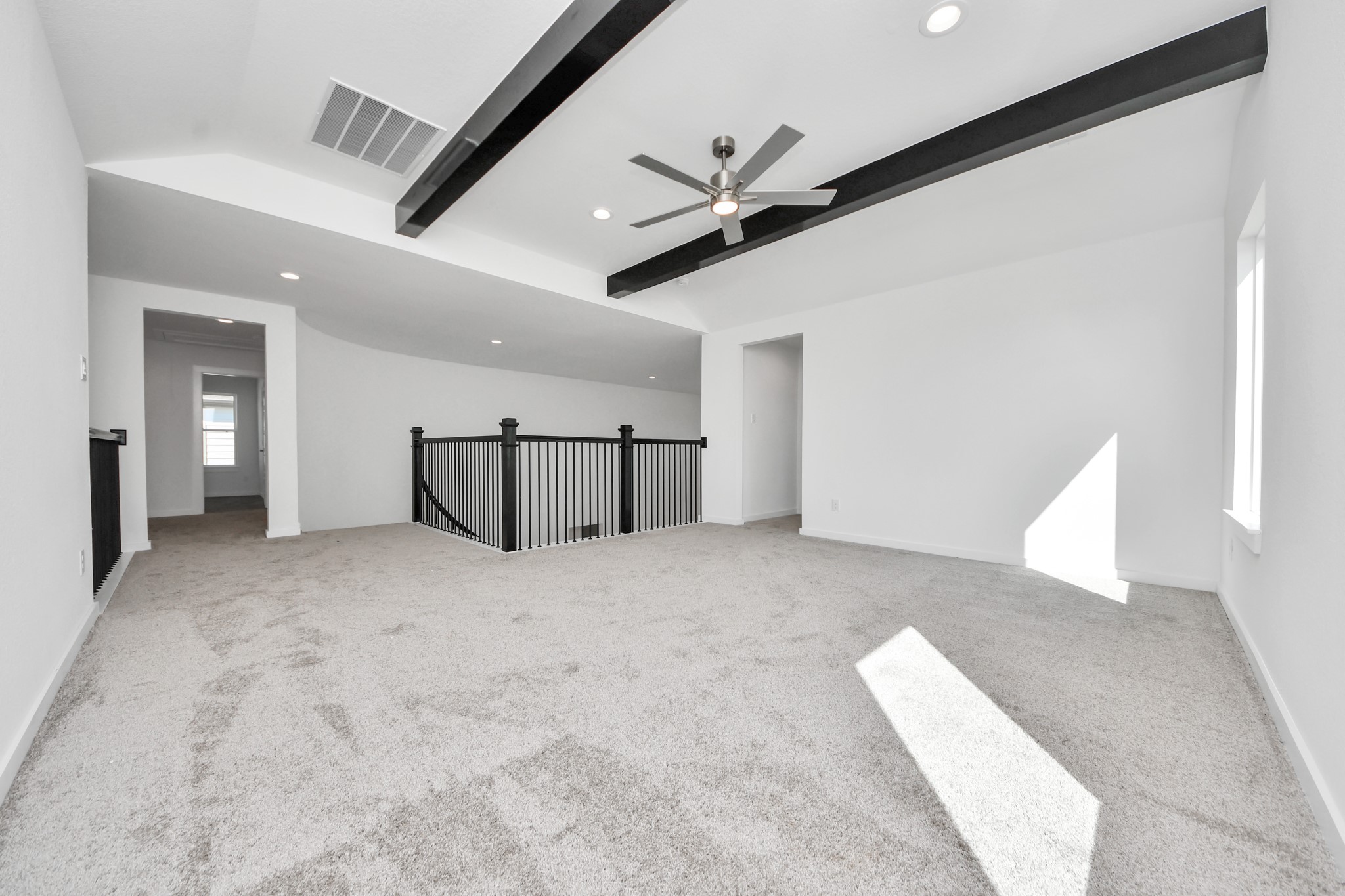 Ascend to relaxation in this fantastic game room! Ideal for both casual gatherings and adult gaming, it boasts plush carpet, lofty ceilings, custom paint, and ample windows for abundant natural light