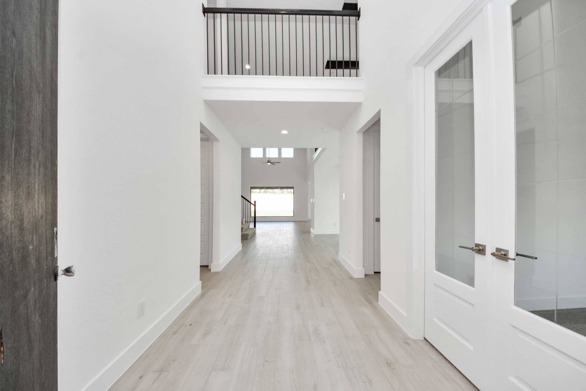 As you step into the threshold of this luxurious home, you'll soon be welcomed by an elegant glass door (to be installed). Inside, soaring ceilings amplify the spaciousness, while the refined wood-look tile flooring and oversized baseboards exude sophistication and charm.