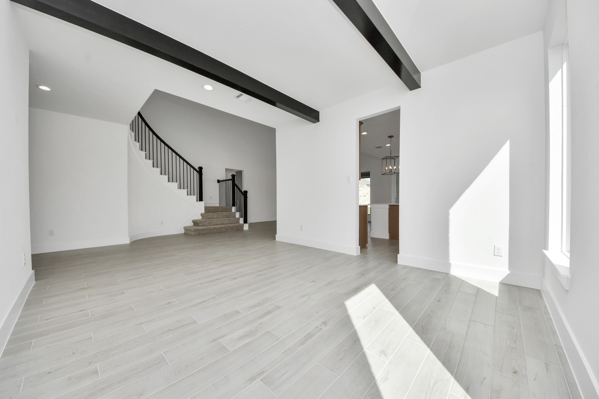Craft enduring memories with loved ones around the table! This roomy dining area boasts stylish flooring, personalized paint, and is conveniently situated next to the family room and kitchen, fostering an open and inclusive ambiance.