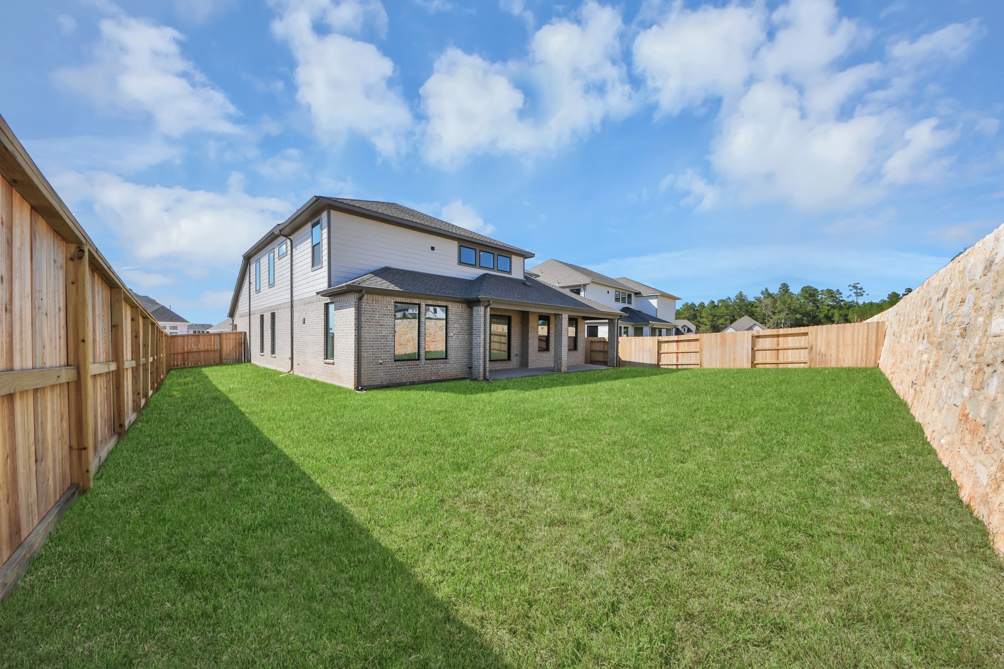 Come and see this spacious backyard with its beautiful covered patio. There is plenty of room for the kids to play and adults to relax. Perfect for your outdoor living space, patio furniture, bbq pit, and so much more. The possibilities are endless!