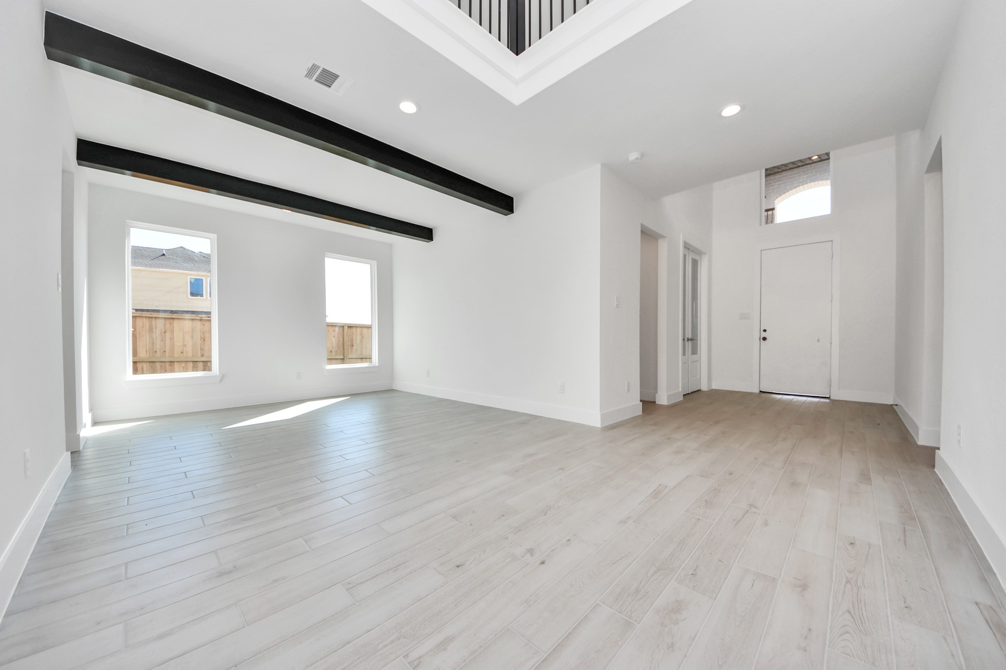 Create lasting memories with your family and friends at the dining table! This expansive dining room showcases sophisticated flooring, custom paint, and seamlessly connects to the family room and kitchen, providing an open and inviting atmosphere