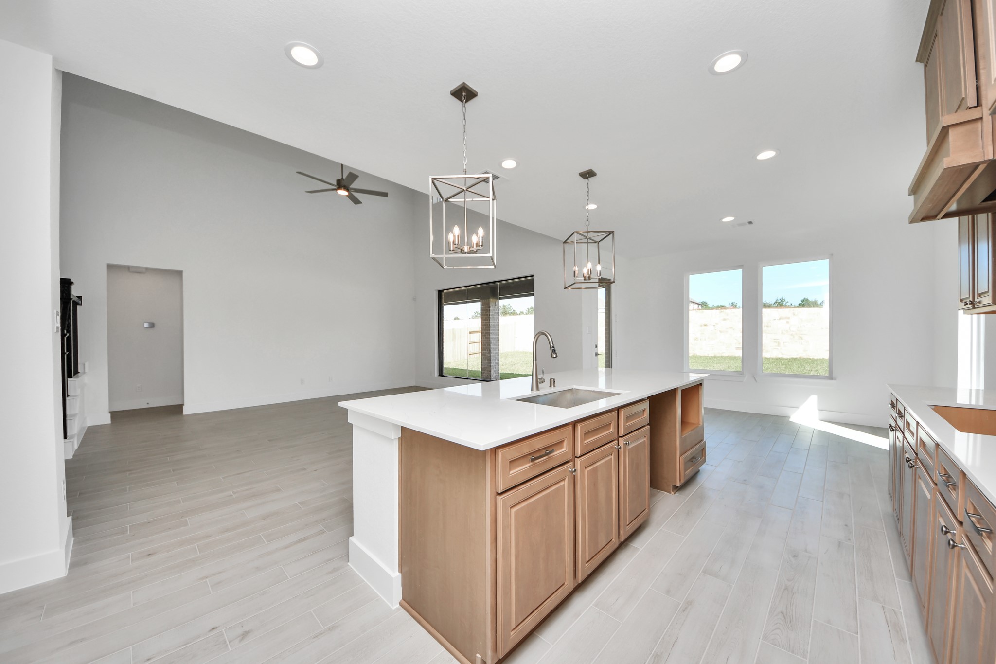 Step into a dream realized with this generously spacious kitchen! A massive granite island takes center stage, complemented by high ceilings and soft-close cabinets. The granite countertops, stainless steel appliances, sleek tile backsplash, and recessed lighting complete the elegant design.