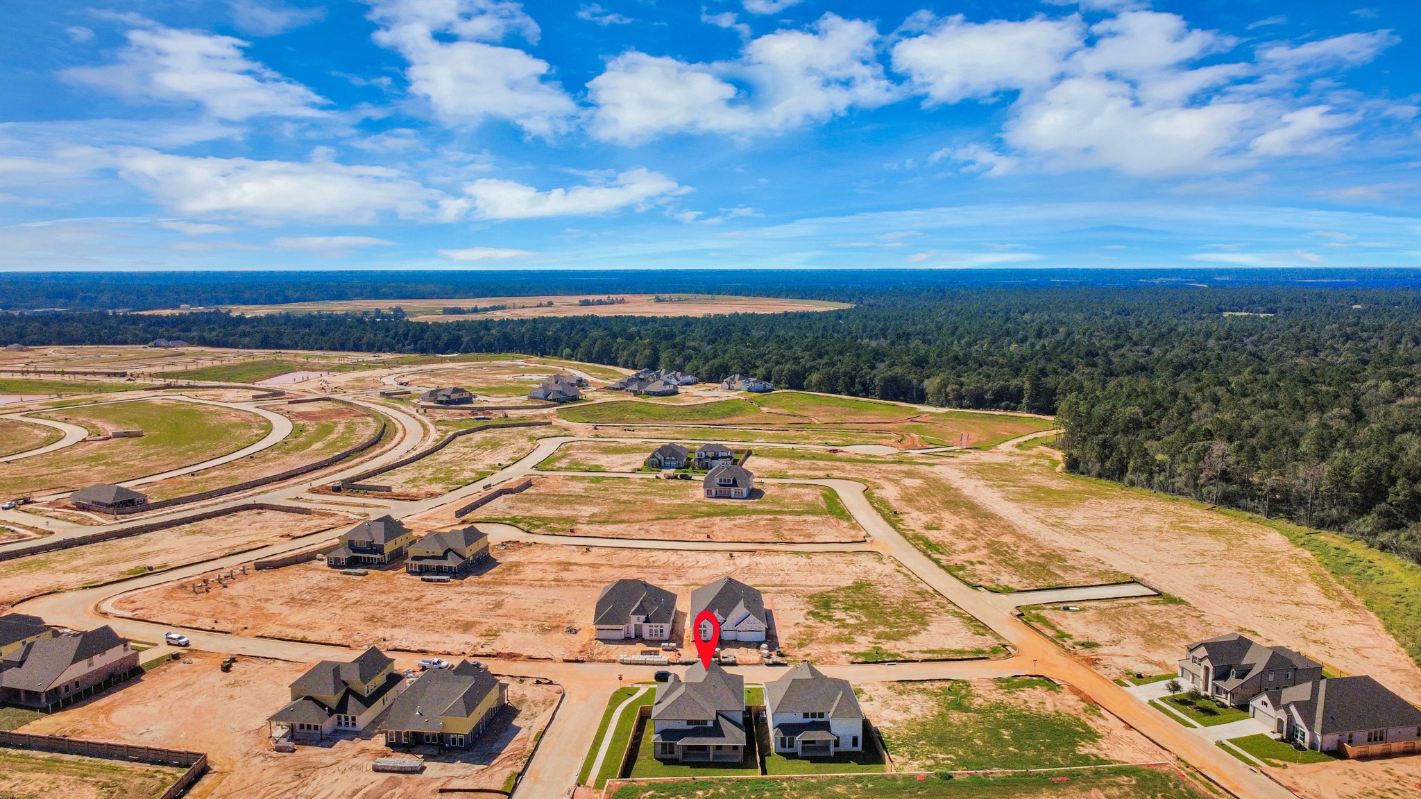 An aerial view of a spacious subdivision lot, highlighting a well-maintained yard and a fully fenced perimeter, offering both privacy and expansive outdoor space.