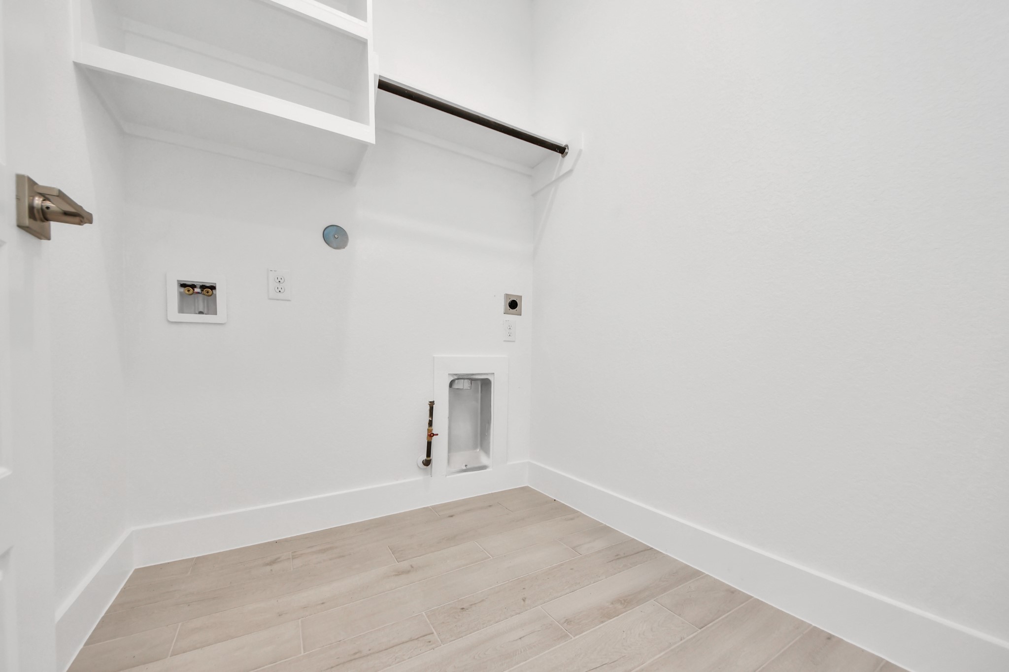A perfect blend of functionality and comfort. Capture the essence of easy living with a first-floor laundry room, thoughtfully equipped with shelving for effortless organization. Both electric and gas connections available.