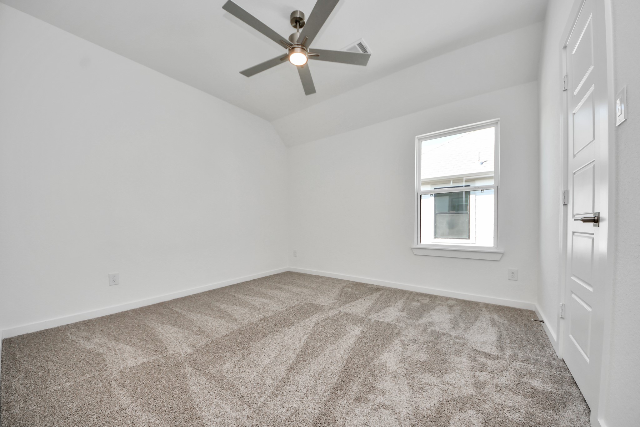 Secondary bedroom features plush carpeting, large windows that let in plenty of natural light, bright paint, and spacious closets.