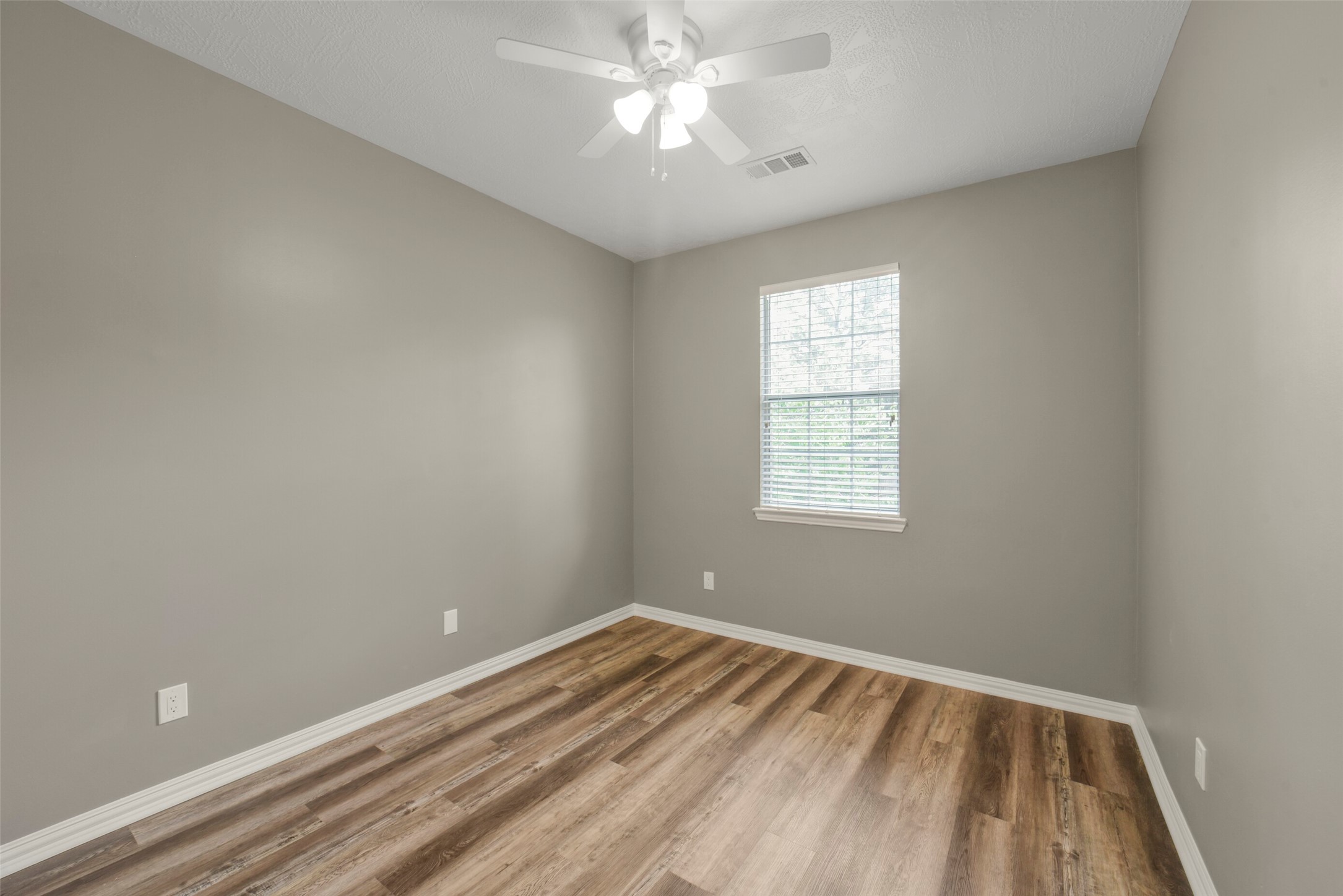A spacious secondary bedroom upstairs features great proportions, a closet, and bright windows.