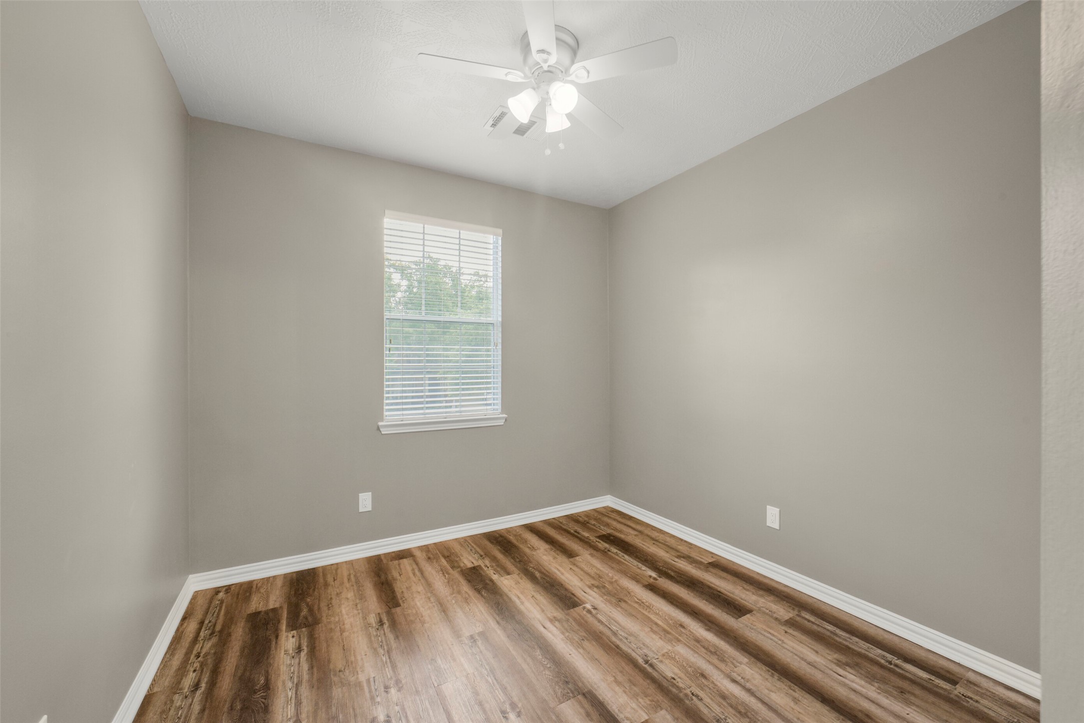 Another bright and roomy upstairs secondary bedroom offers a comfortable and private retreat for family or guests.