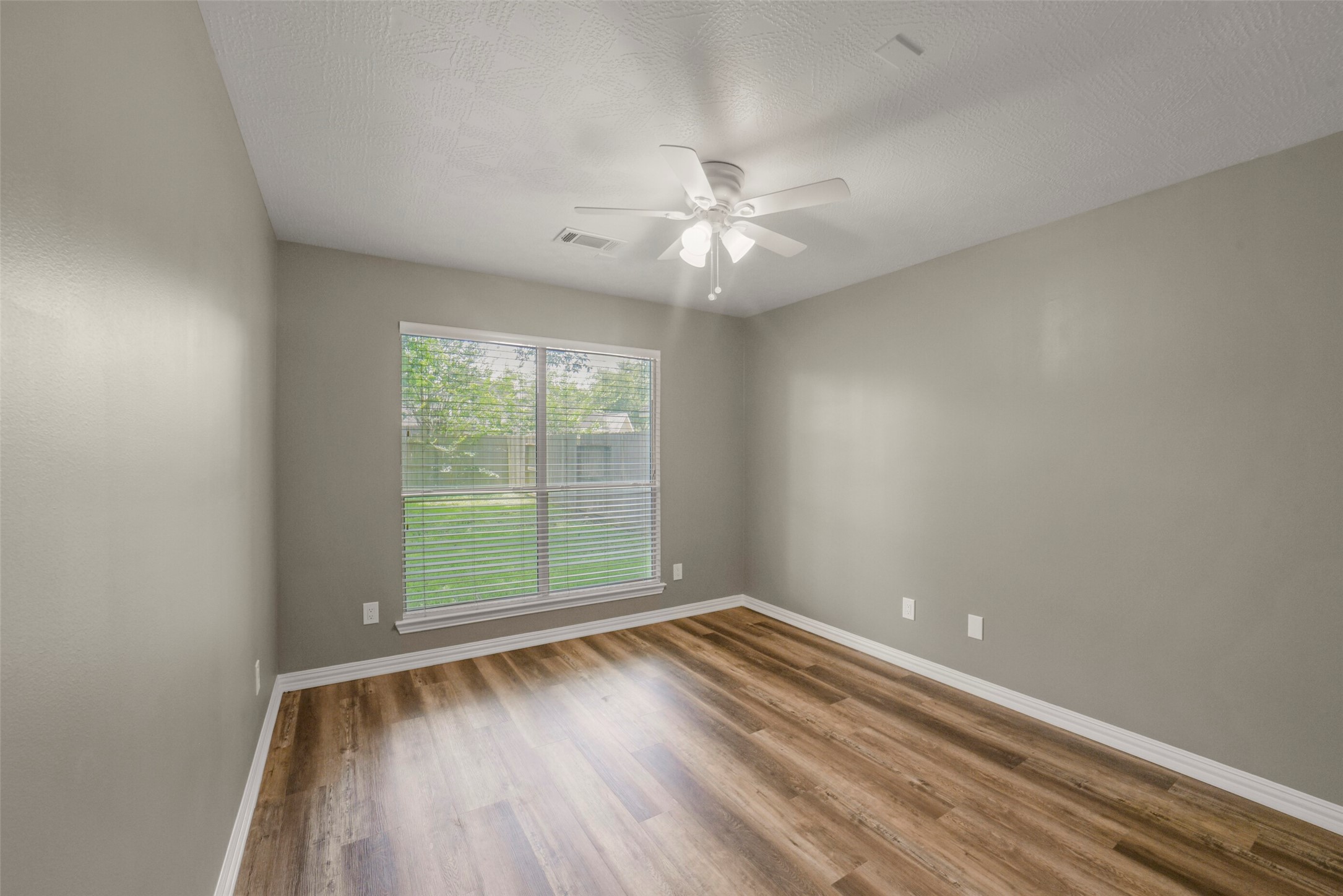 The versatile downstairs office/study features a flexible layout that can easily serve as a comfortable main-floor guest room.