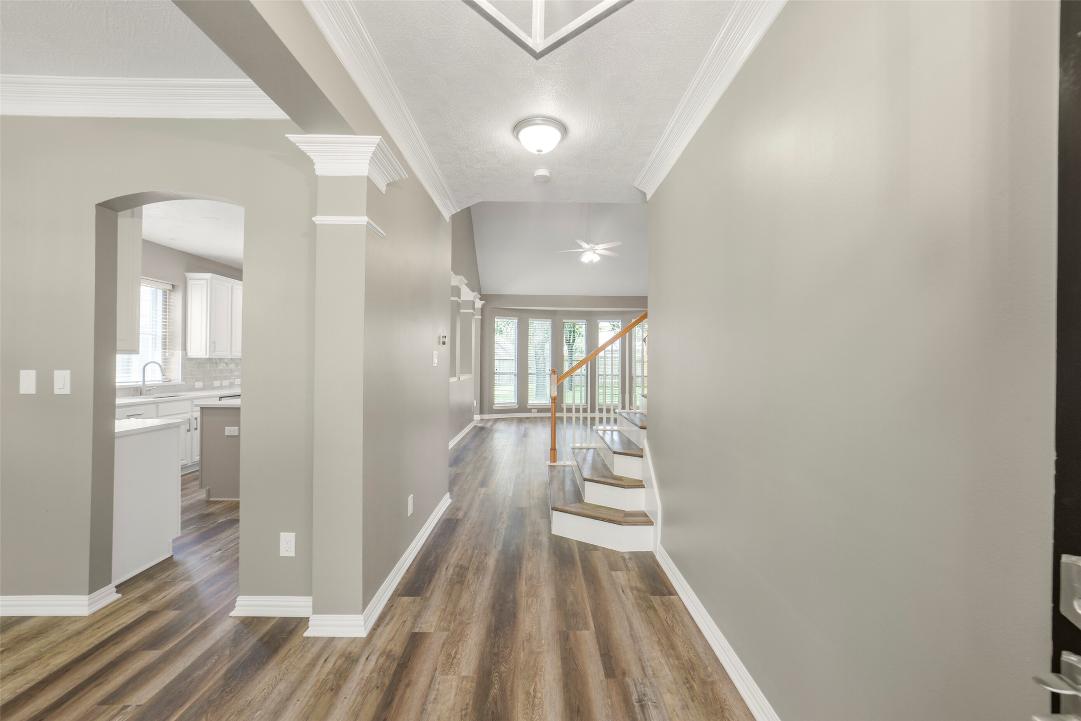 A grand and inviting entry features elegant wood floors that set a sophisticated tone the moment you step inside.