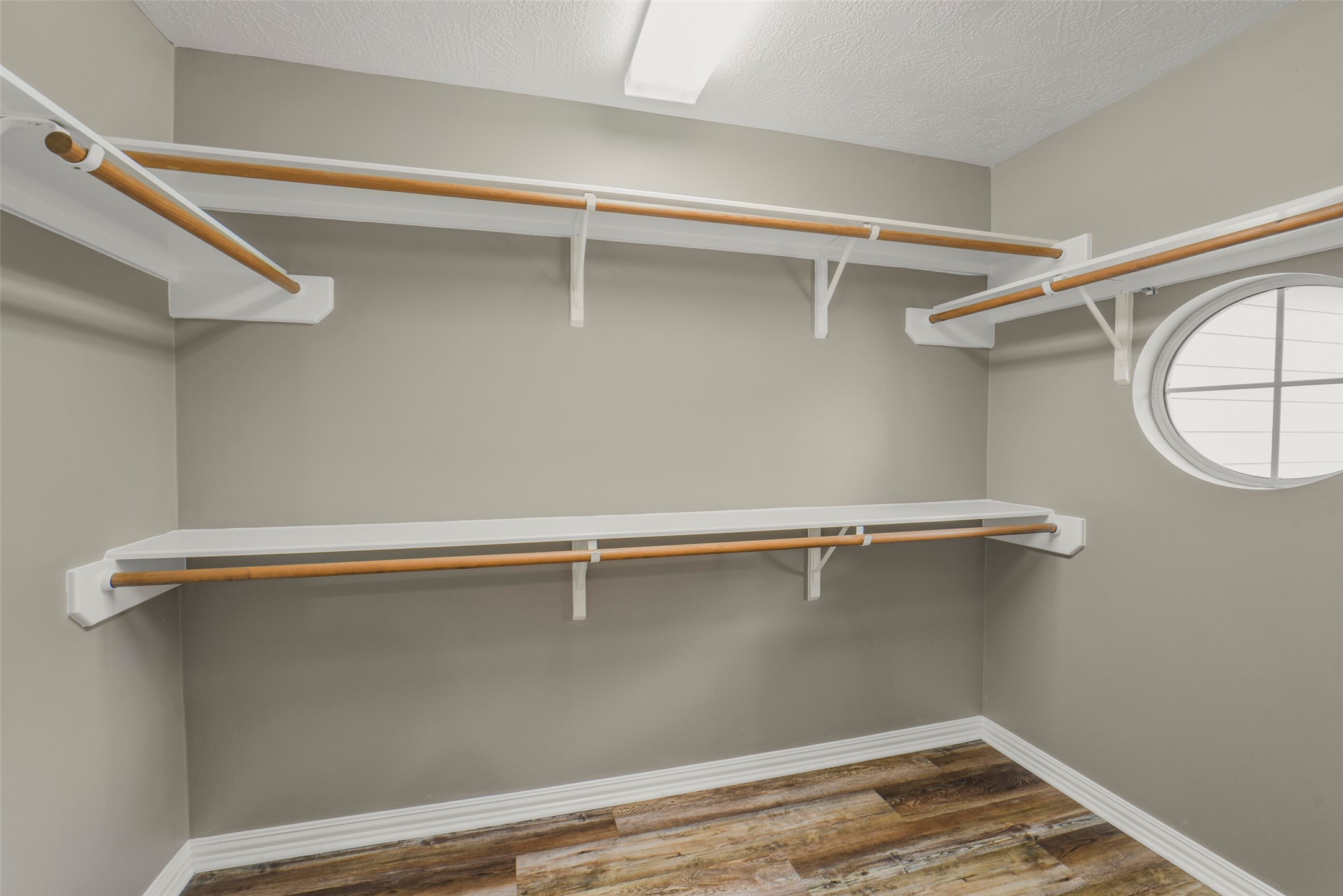 The massive primary walk-in closet boasts extensive built-in shelving and ample storage for a complete wardrobe.