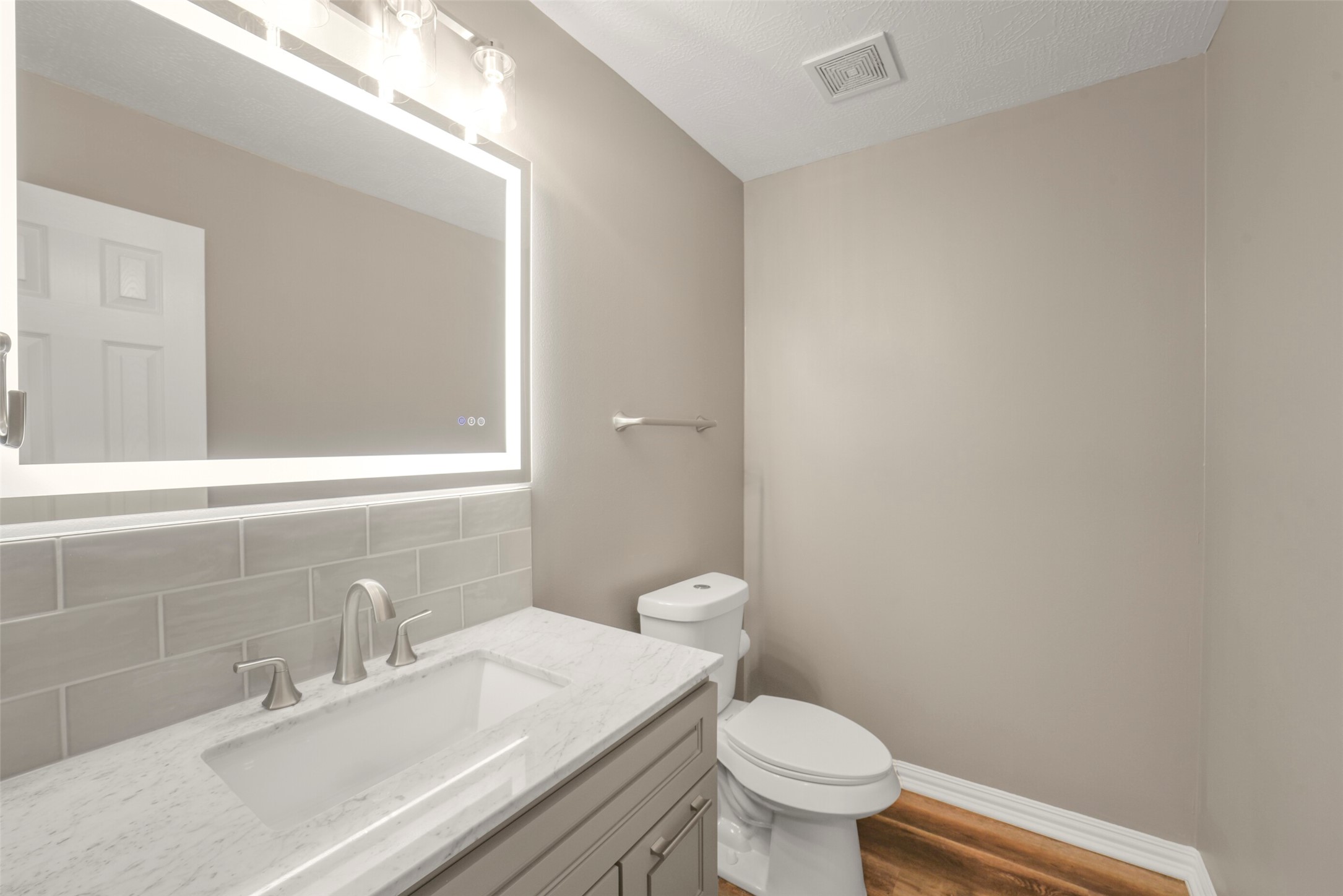 A beautifully appointed half bath downstairs offers convenience for guests and features modern fixtures.