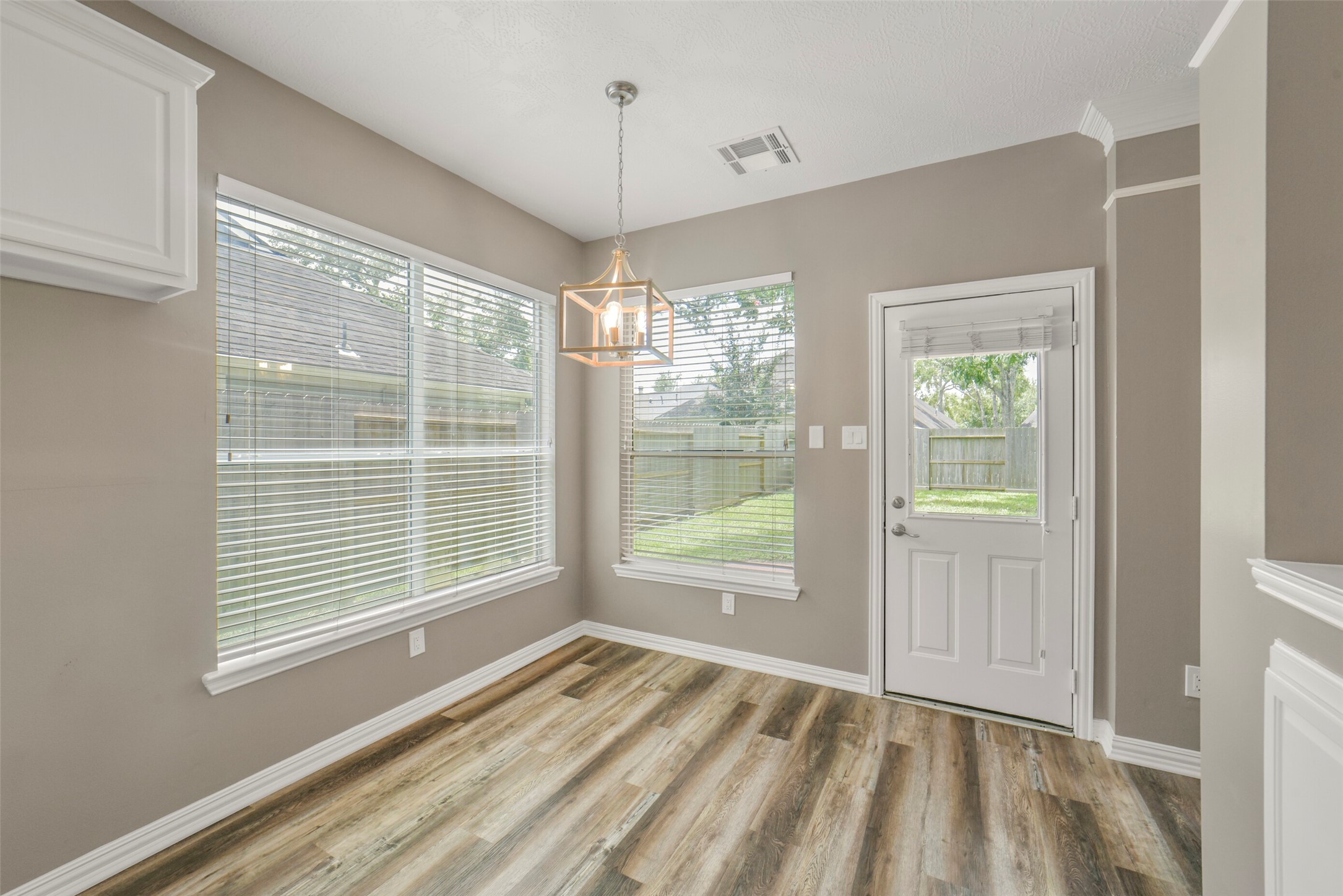 Located right off the kitchen, the bright breakfast area offers a lovely spot for morning coffee and convenient door access directly to the outdoor space.