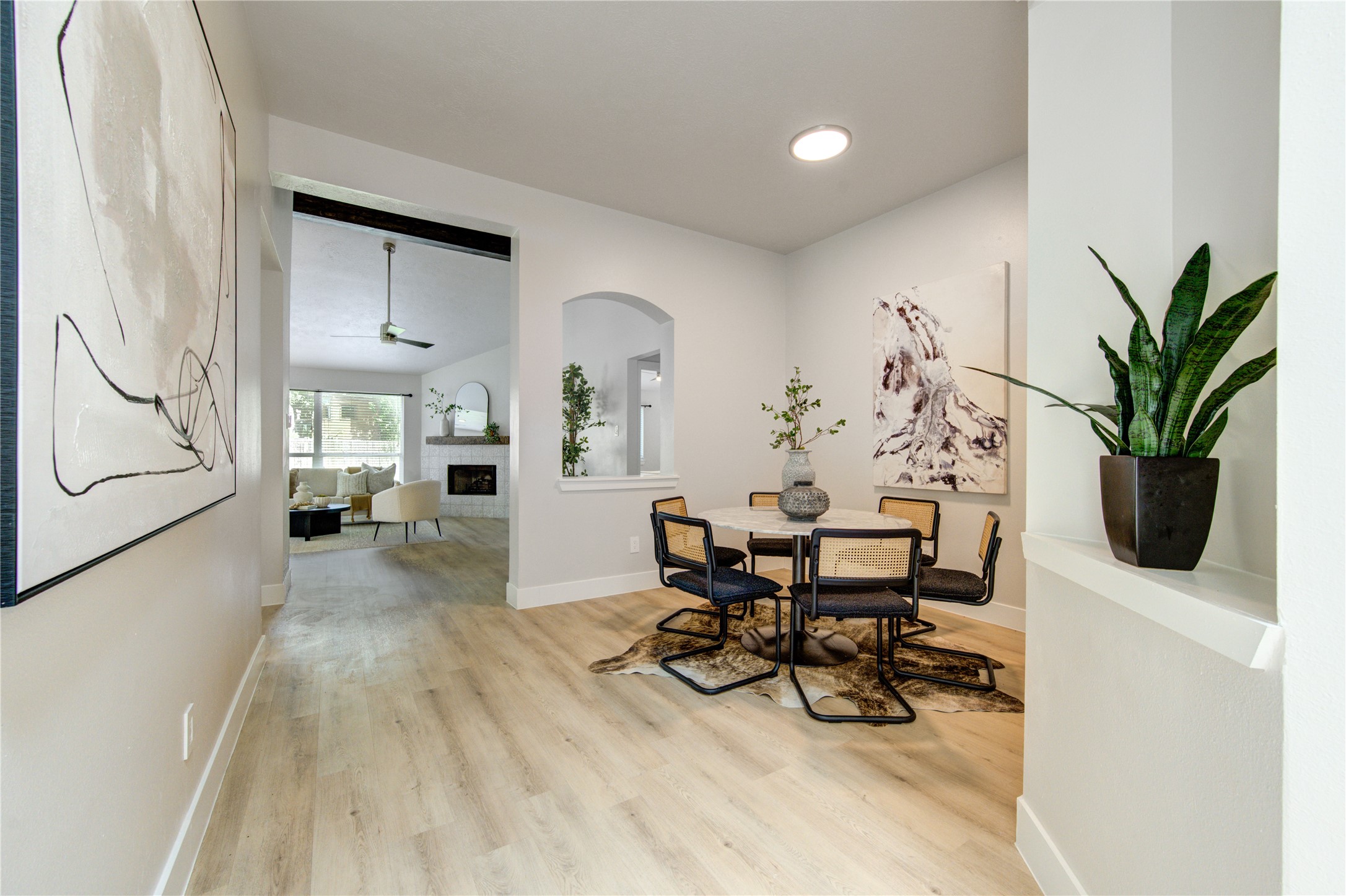 Staged to showcase a dining setting with an effortless flow into the living room