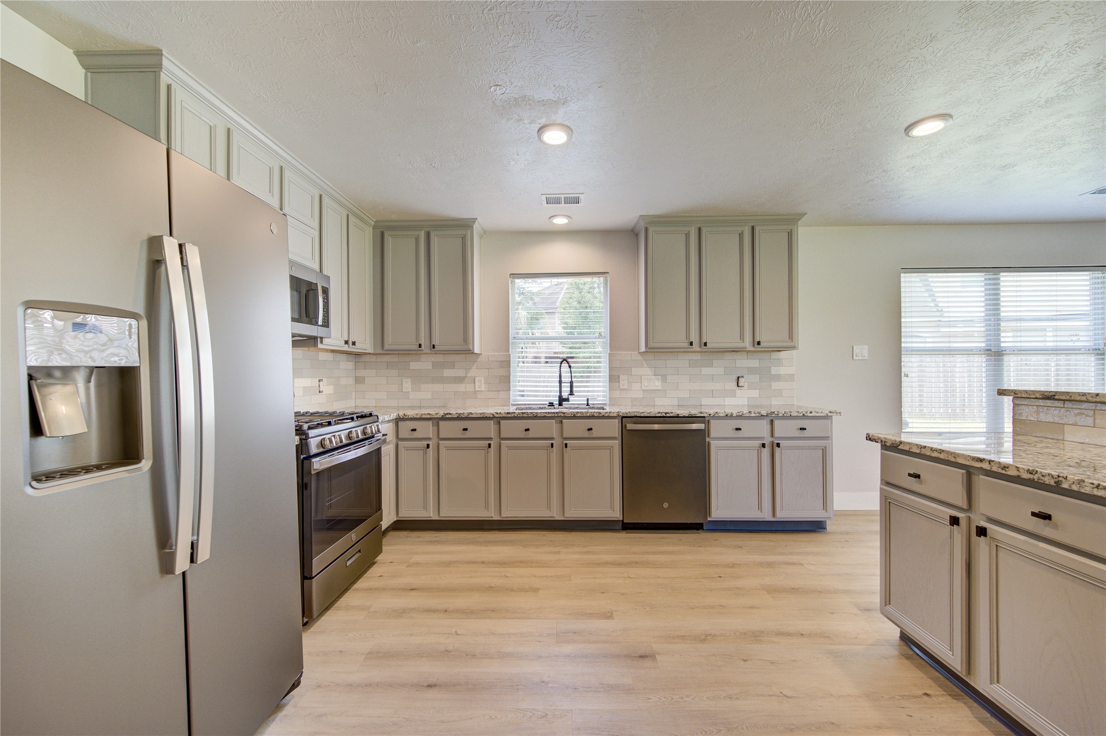 Designed for both style and function, the kitchen features stainless steel appliances, a gas range, modern finishes and generous prep space for the home chef