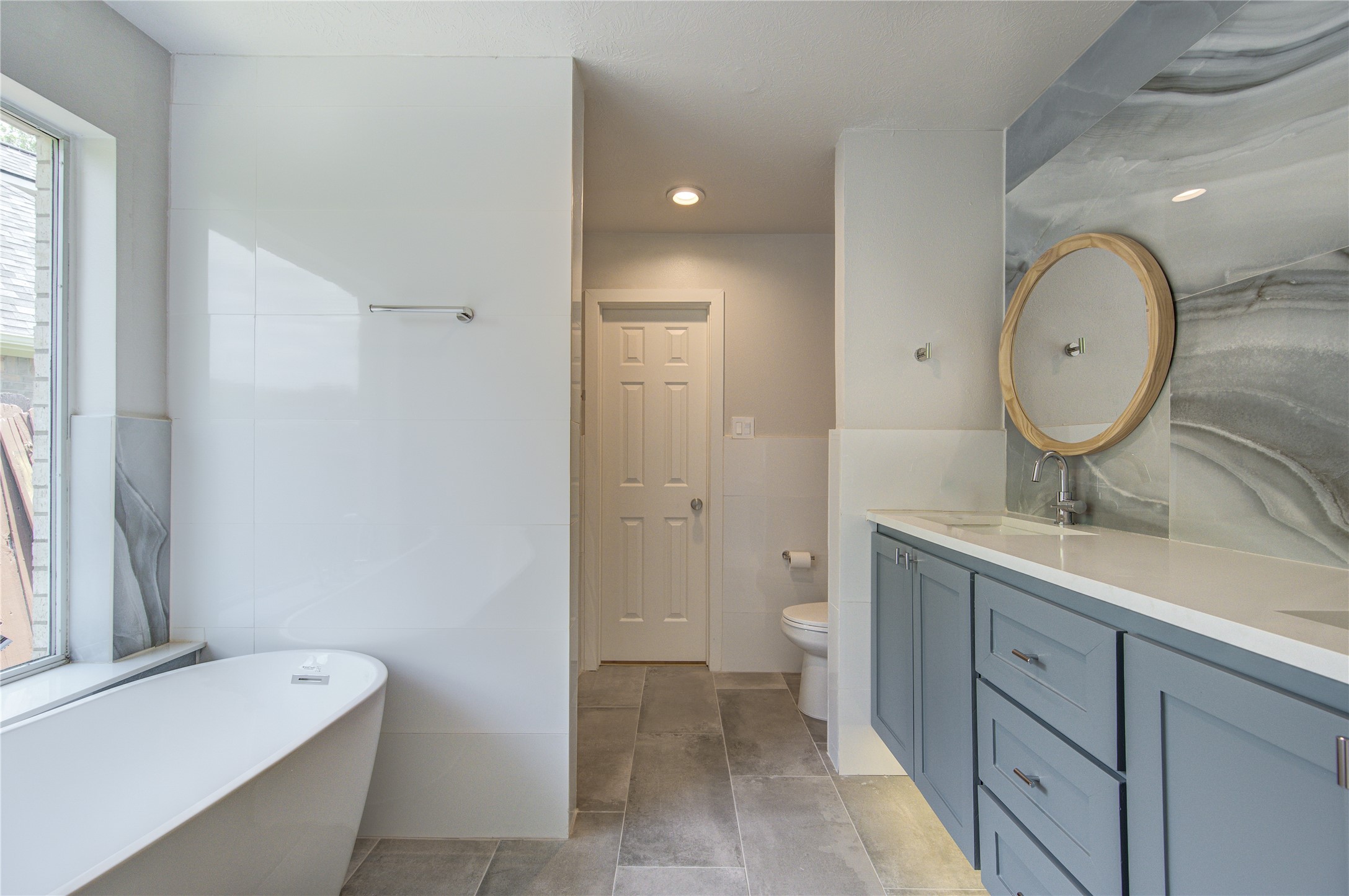 Primary Bath features floating cabinets with under cabinet LED lighting