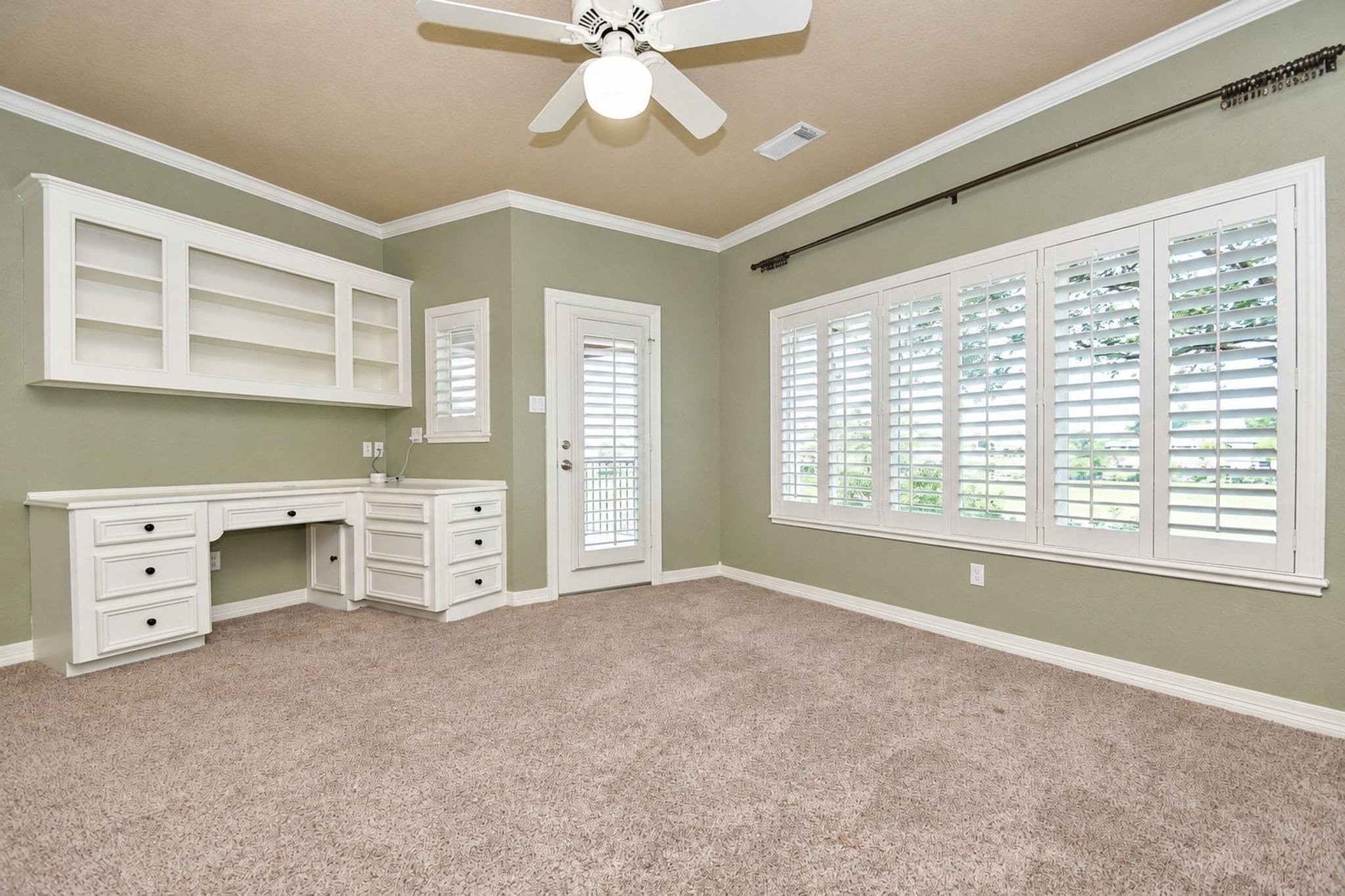This expansive and light-filled upstairs bedroom features floor-to-ceiling windows that bathe the space in natural sunlight. The room is further enhanced by sophisticated custom built-in cabinetry offering ample storage and elegant display space, while a sliding glass door provides seamless, direct access to a private, peaceful patio perfect for morning coffee or evening relaxation!