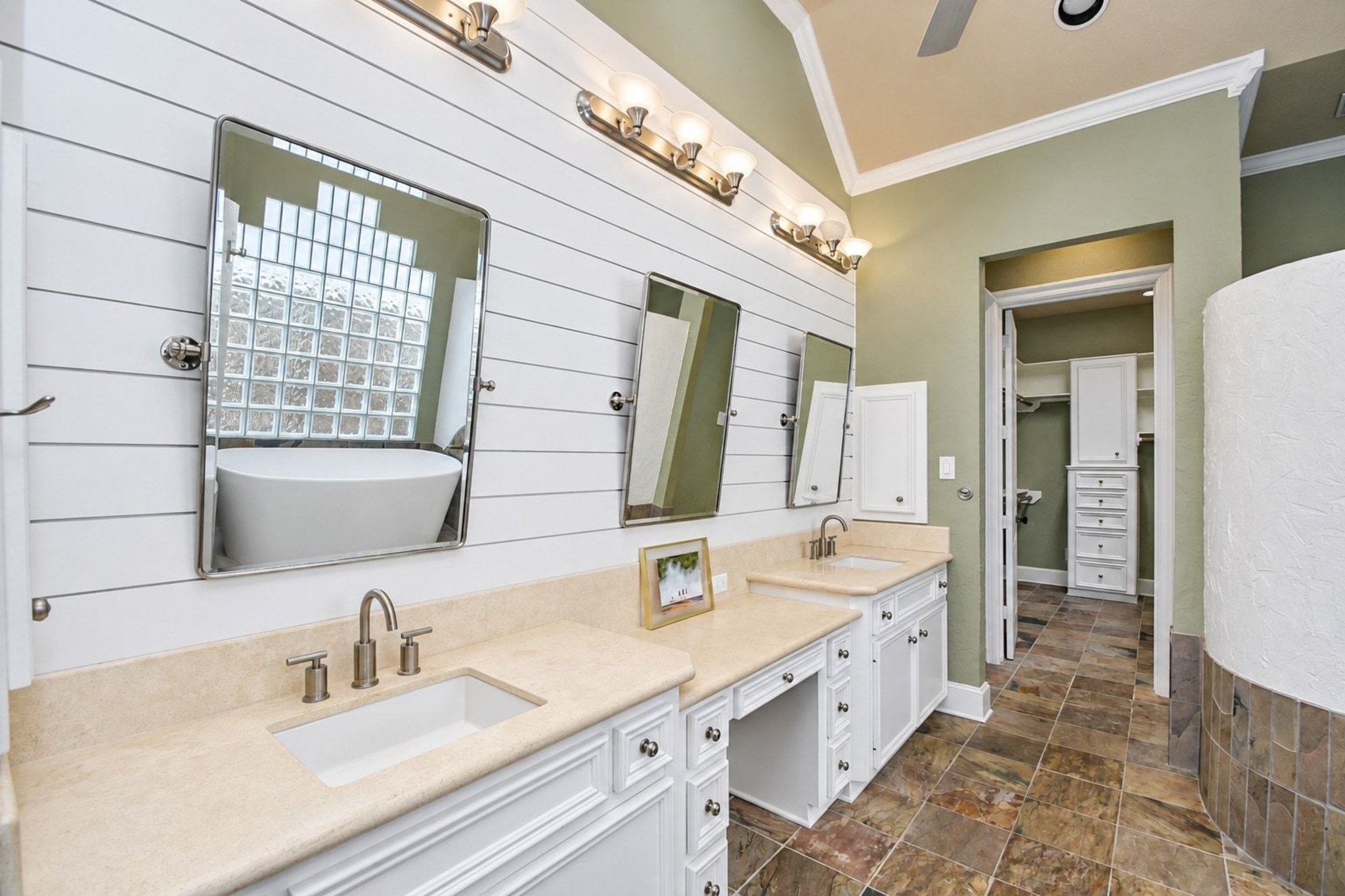 This beautifully custom primary bathroom serves as a luxurious retreat, featuring an expansive double vanity equipped with elegant dual sinks, premium finishes, and ample counter space, providing both style and convenience for busy mornings and relaxing evenings!