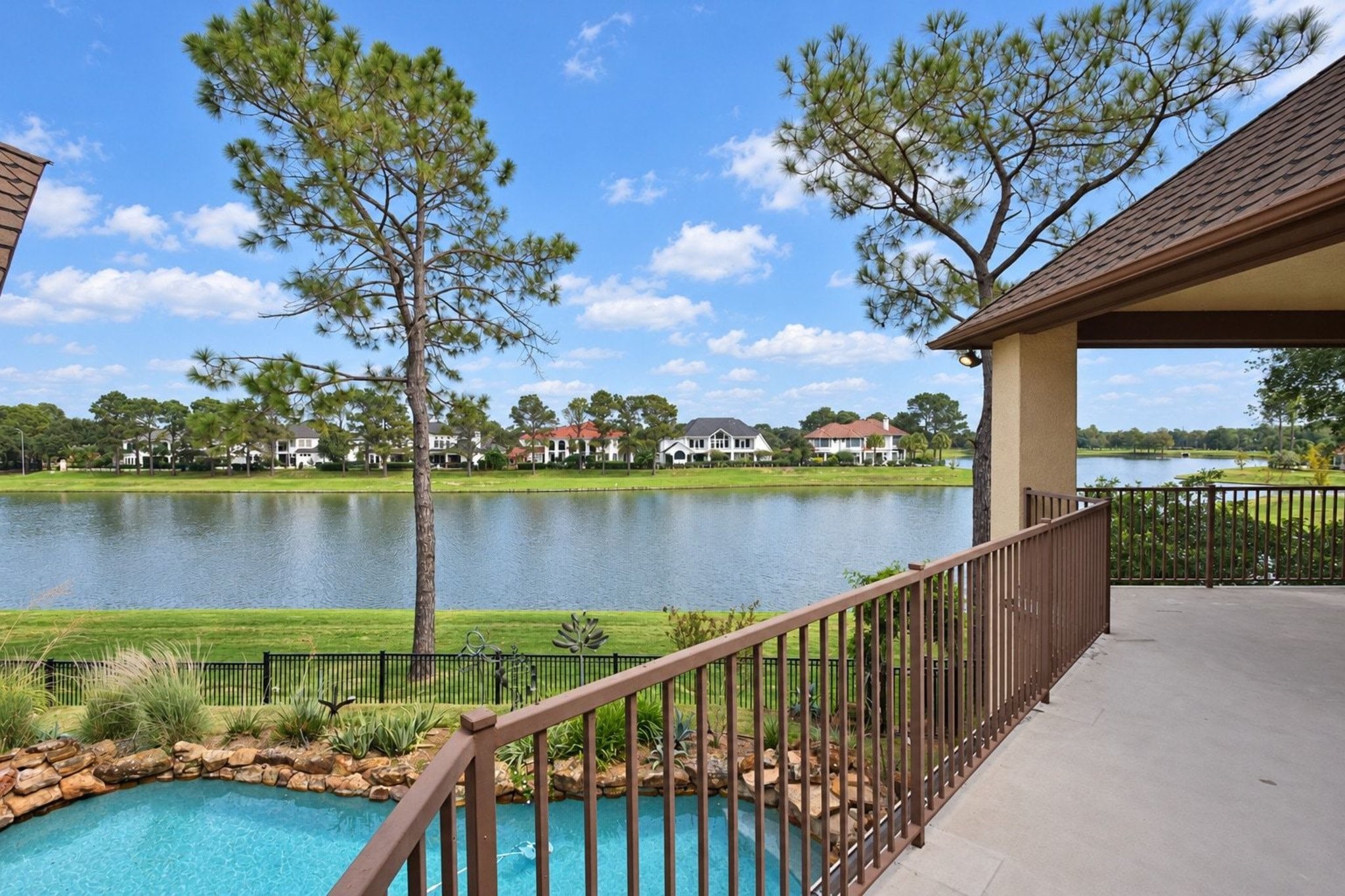 Large covered upstairs patio providing expansive, panoramic views of the surrounding landscape. This elevated outdoor living space offers the perfect vantage point for sunset watching and alfresco dining!