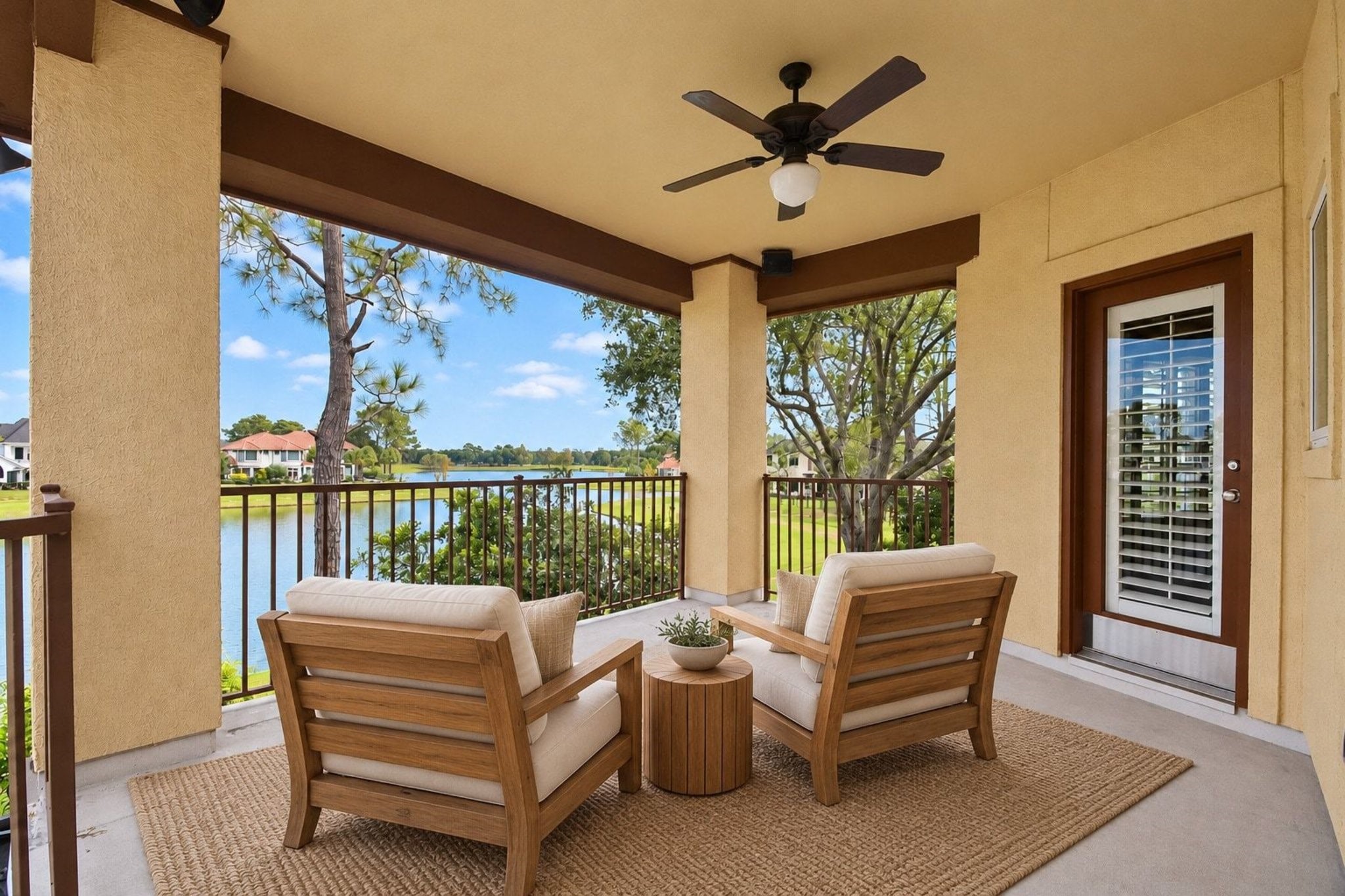 This image features professional virtual staging to showcase the potential of the upstairs patio, an inviting outdoor space perfectly positioned to enjoy tranquil, panoramic views of both the serene lake and the sparkling pool below!