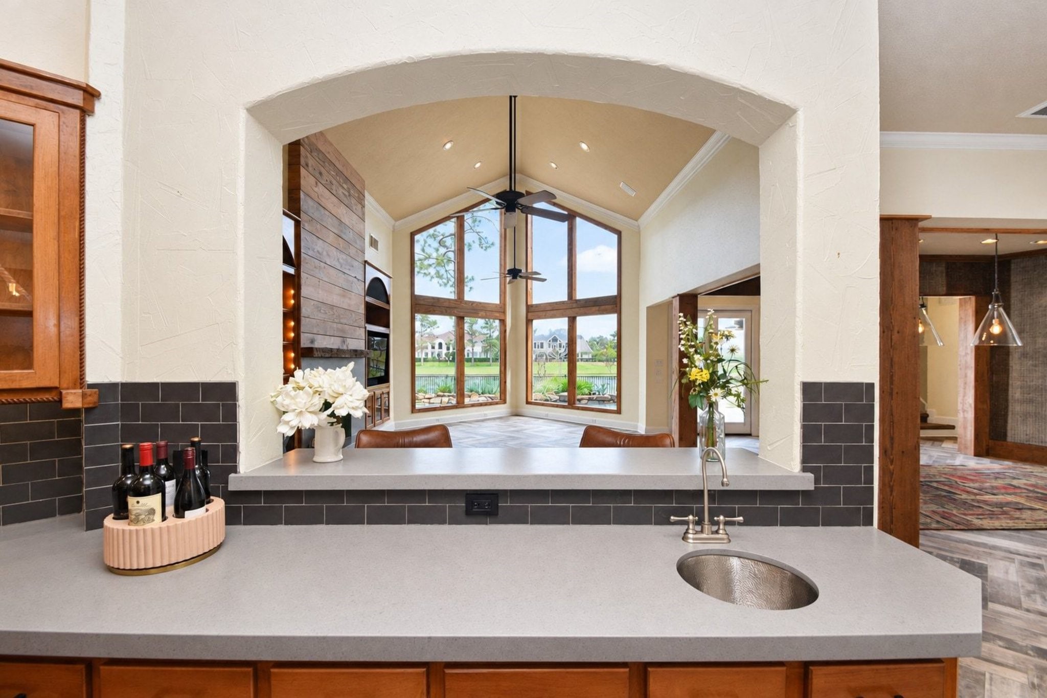 View from the kitchen looking into the spacious living area, characterized by magnificent panoramic views and an abundance of natural light!