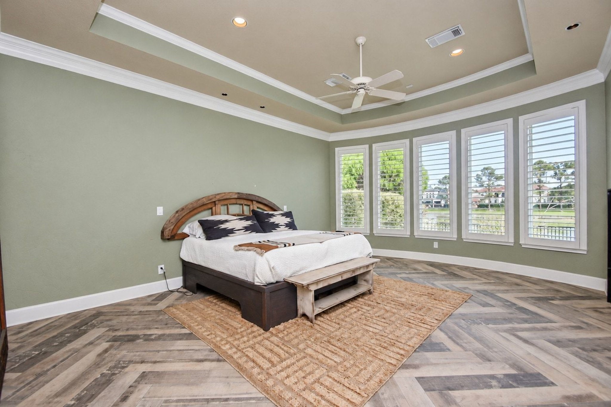 Master bedroom featuring custom paint and large, light-filled windows!