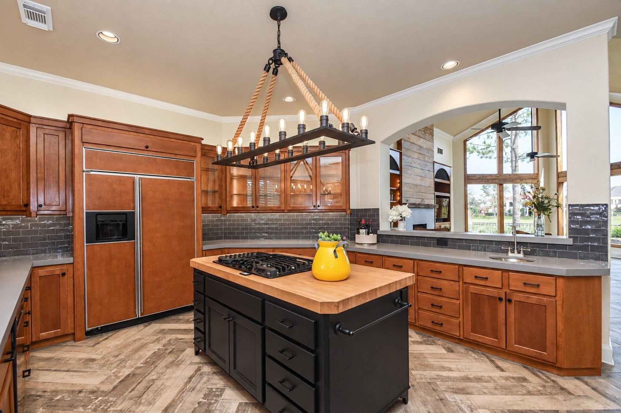 Beautiful kitchen featuring a gourmet cooktop island, perfect for culinary enthusiasts and entertaining. This spacious area offers premium finishes, ample counter space, and a functional layout that serves as the heart of the home!