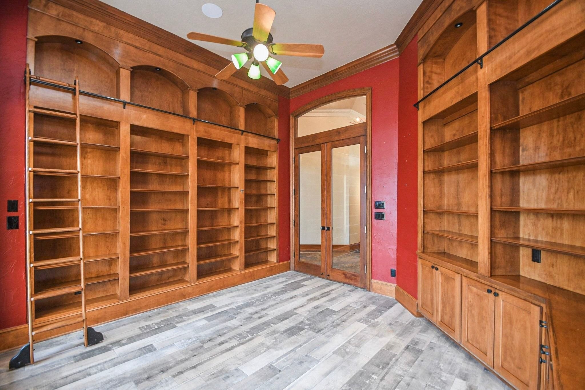 Capture the intricate craftsmanship of the study library with this alternate angle, highlighting the high-end custom cabinetry, extensive built-in shelving, and the sophisticated architectural details that make this professional workspace a standout feature of the home!