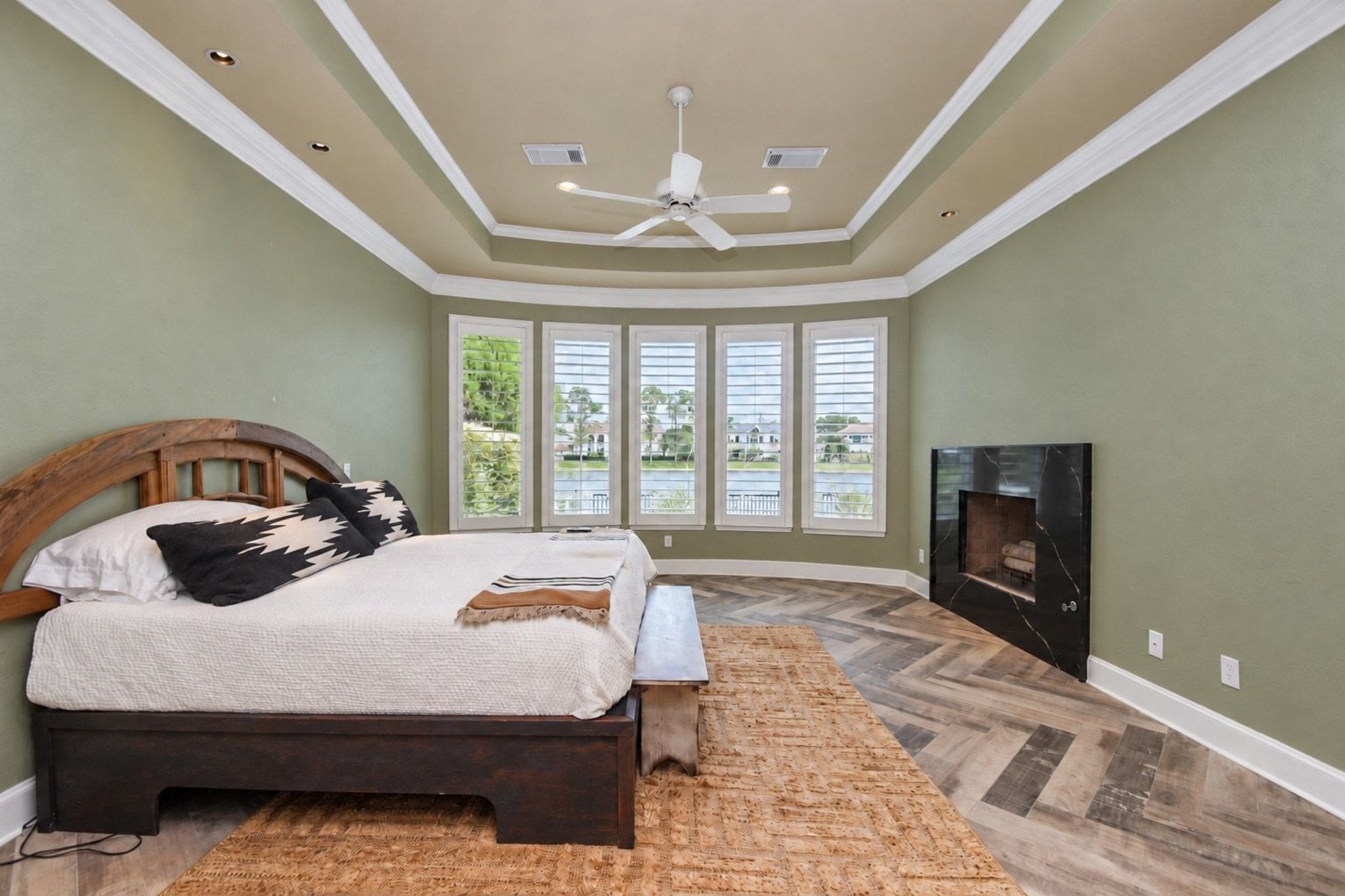 This spacious master bedroom serves as a serene retreat, beautifully enhanced by a sophisticated custom paint palette that adds a touch of modern elegance to the room. Beyond its aesthetic appeal, the suite features an exceptionally large, well-organized closet that provides ample storage and functional utility, catering to the needs of discerning buyers who prioritize both style and practical living space in their search for the perfect home.windows