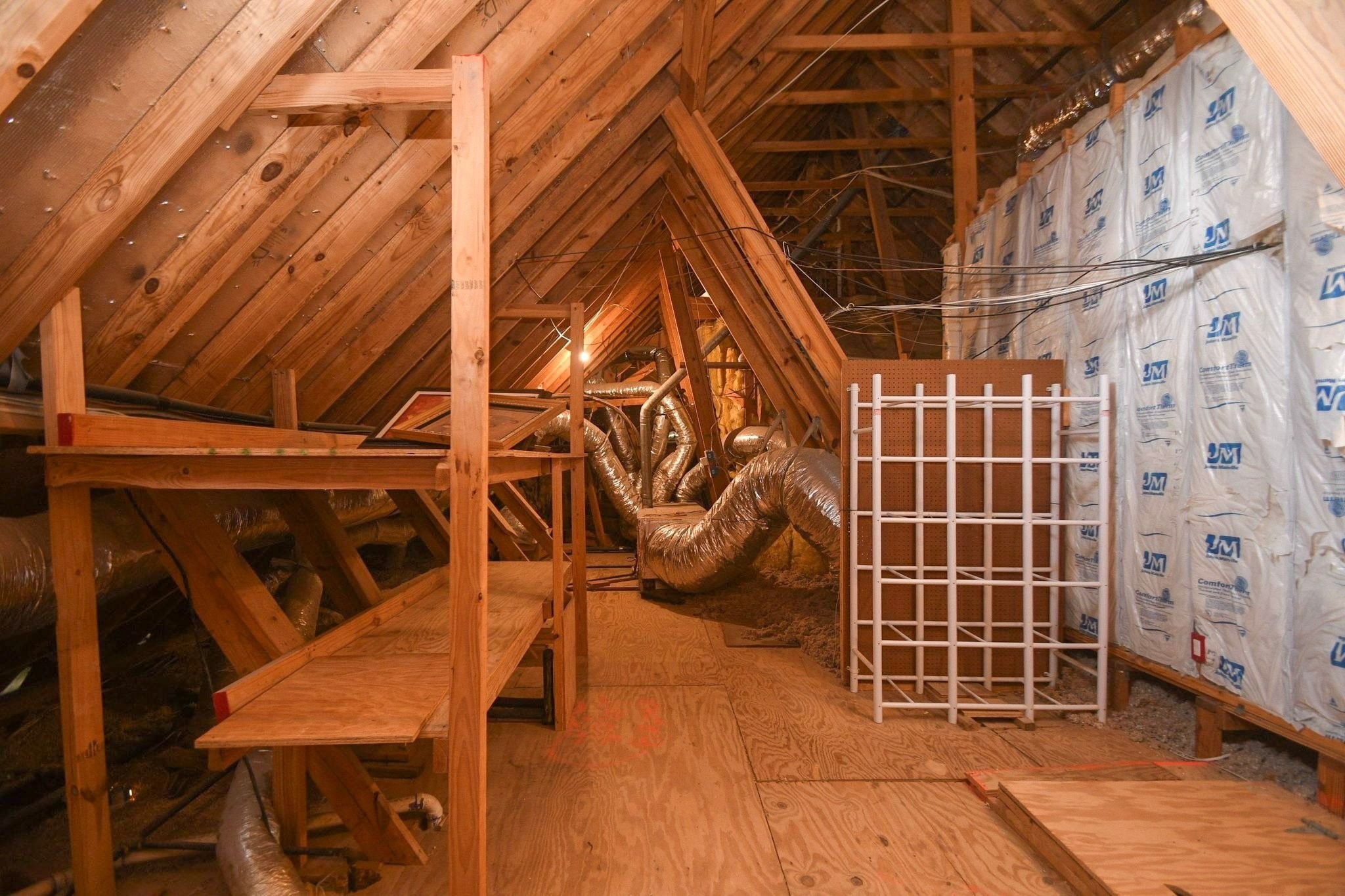 Spacious attic area featuring extensive decking, providing ample and convenient storage solutions throughout the upper level.