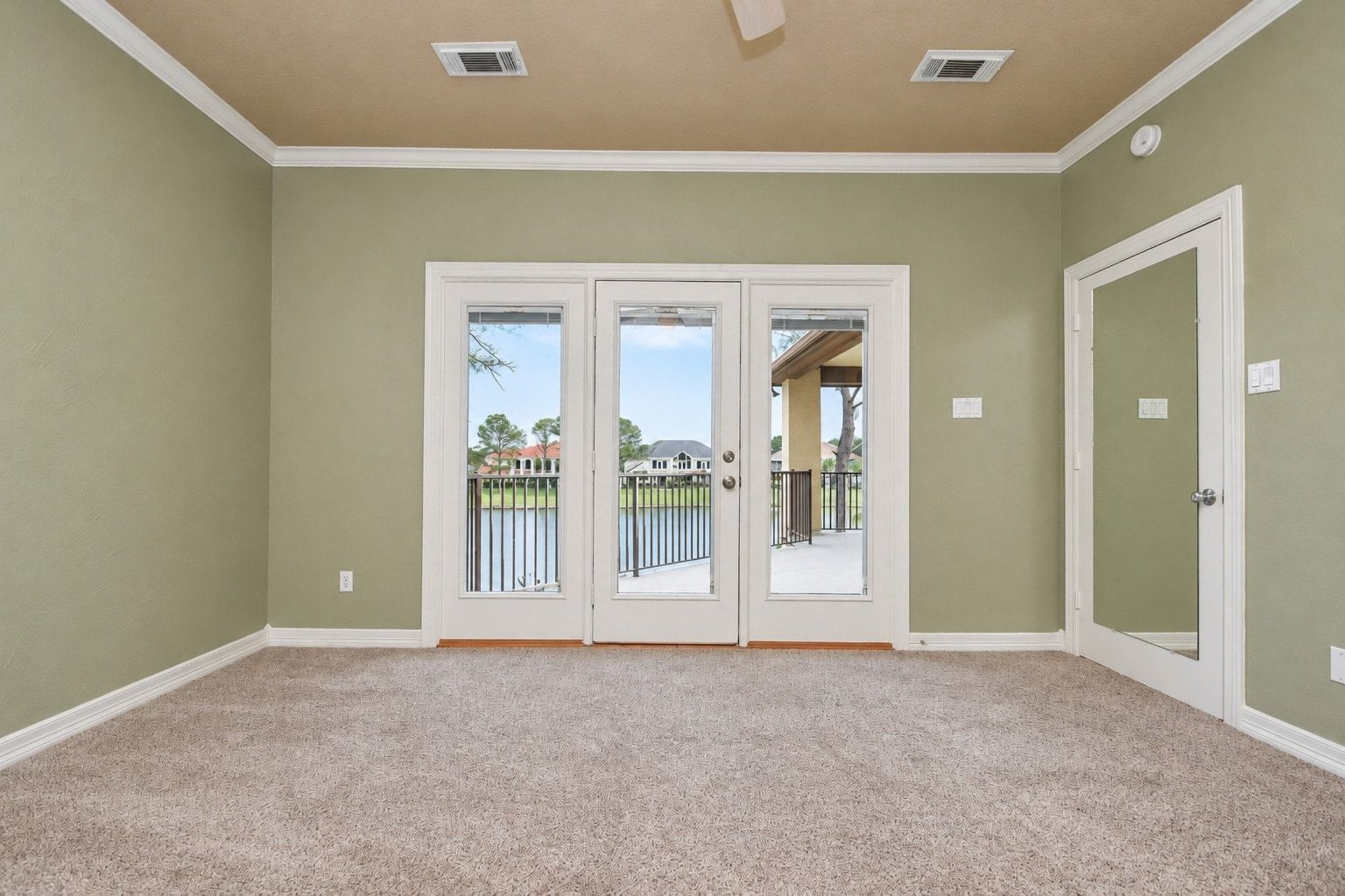 Located on the second level, this spacious upstairs bedroom offers a serene retreat enhanced by expansive, unobstructed panoramic windows that showcase stunning views of the surrounding landscape, perfectly capturing the natural light and scenic beauty of the area!