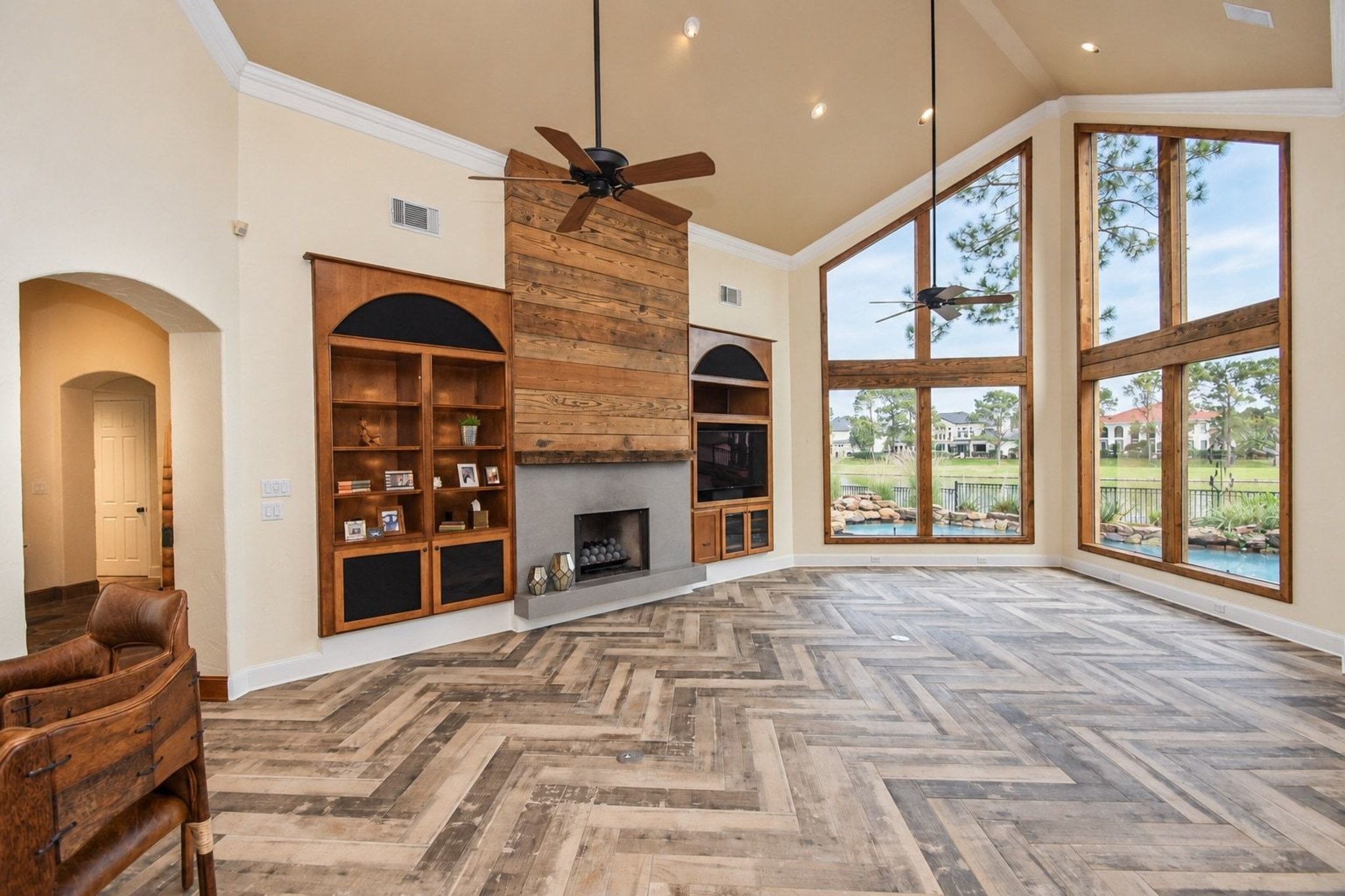 Tons of windows flooding the home with natural light and offering stunning views. The open-concept living space is perfect for entertaining and features high-end custom built-ins, complemented by a cozy gas fireplace that serves as a beautiful centerpiece!