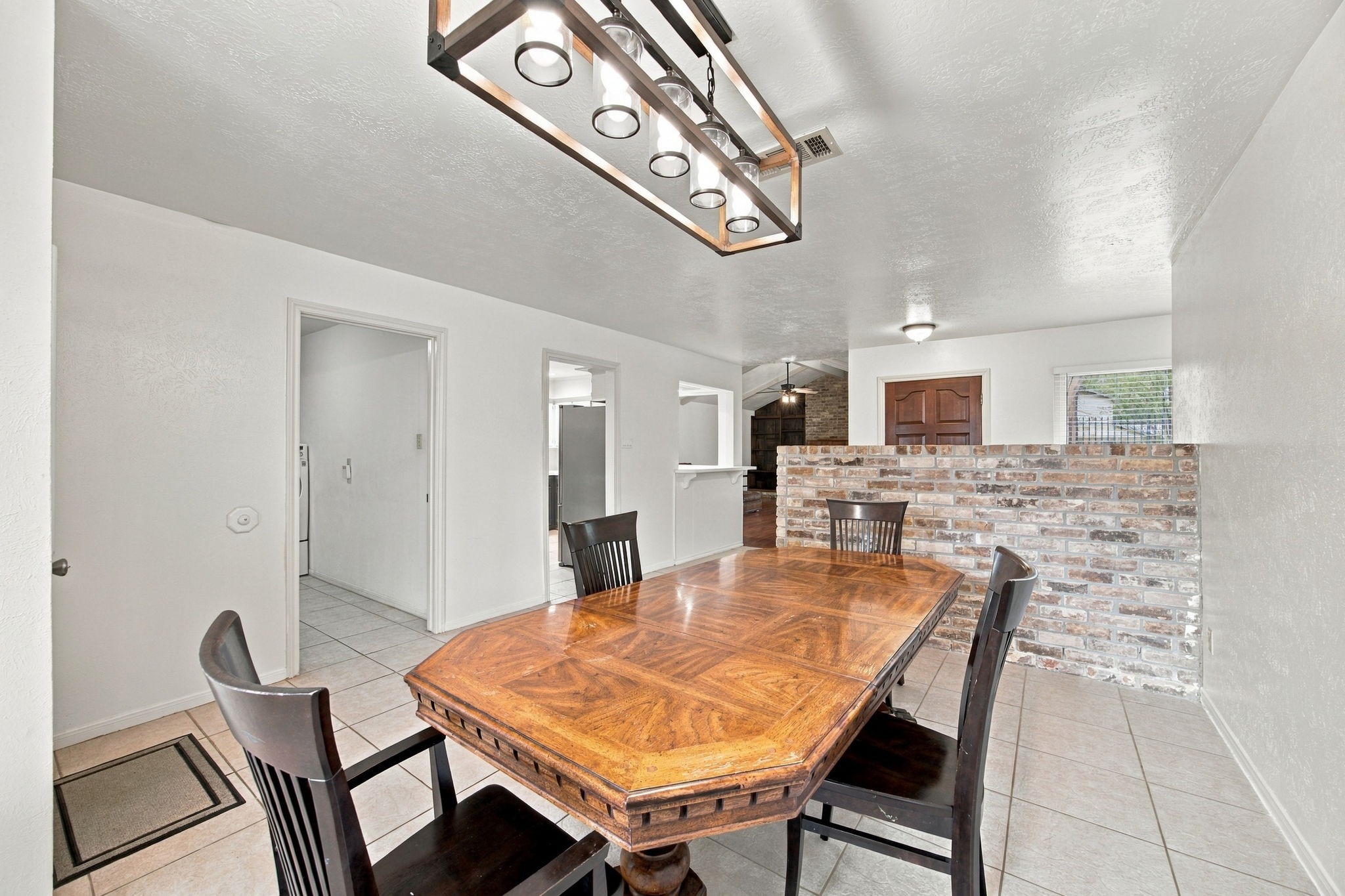 This dining room is large.  This eight-person table fits with plenty of seating and space for additional furniture.