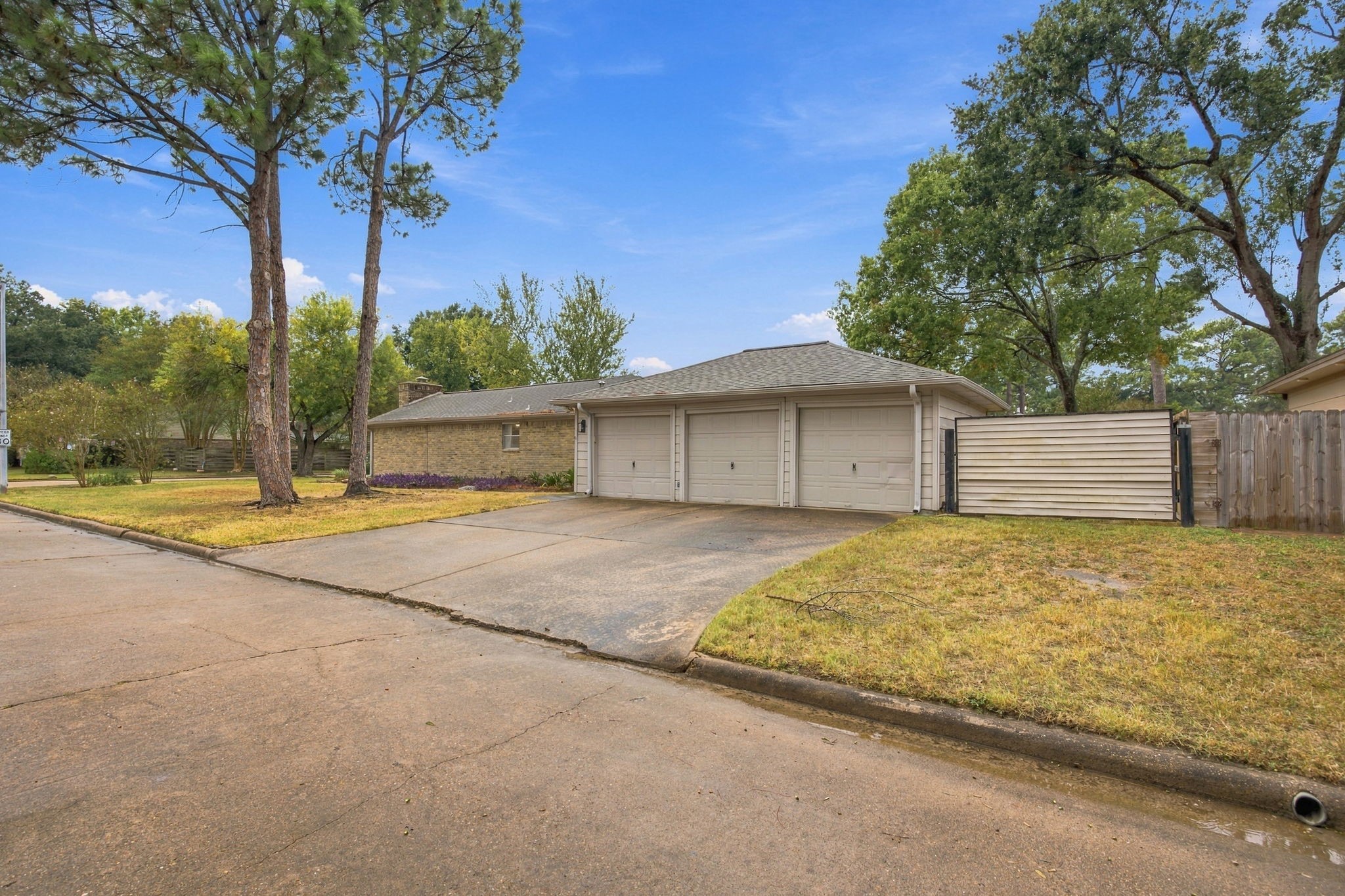 Three car garage with additional parking to the side. Perfect for the mechanic of the family or a small trailer. Three car garage with additional parking to the side. Perfect for the mechanic of the family or a small trailer.