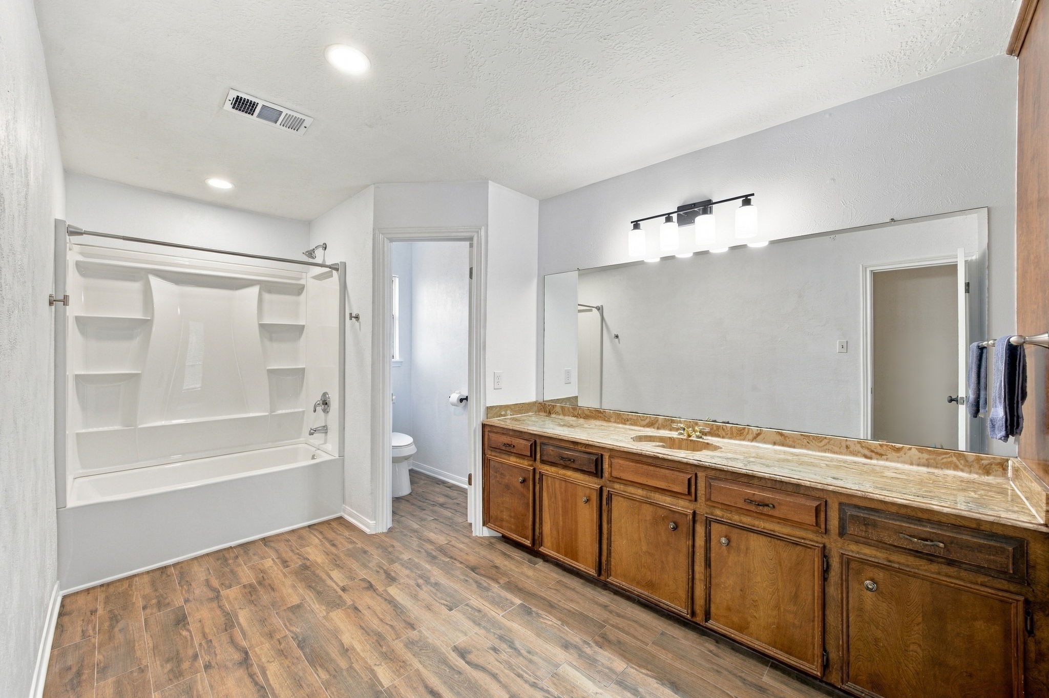 This guest bathroom is very large.  It has plenty of room for future expension of the shower or even more cabinetry.