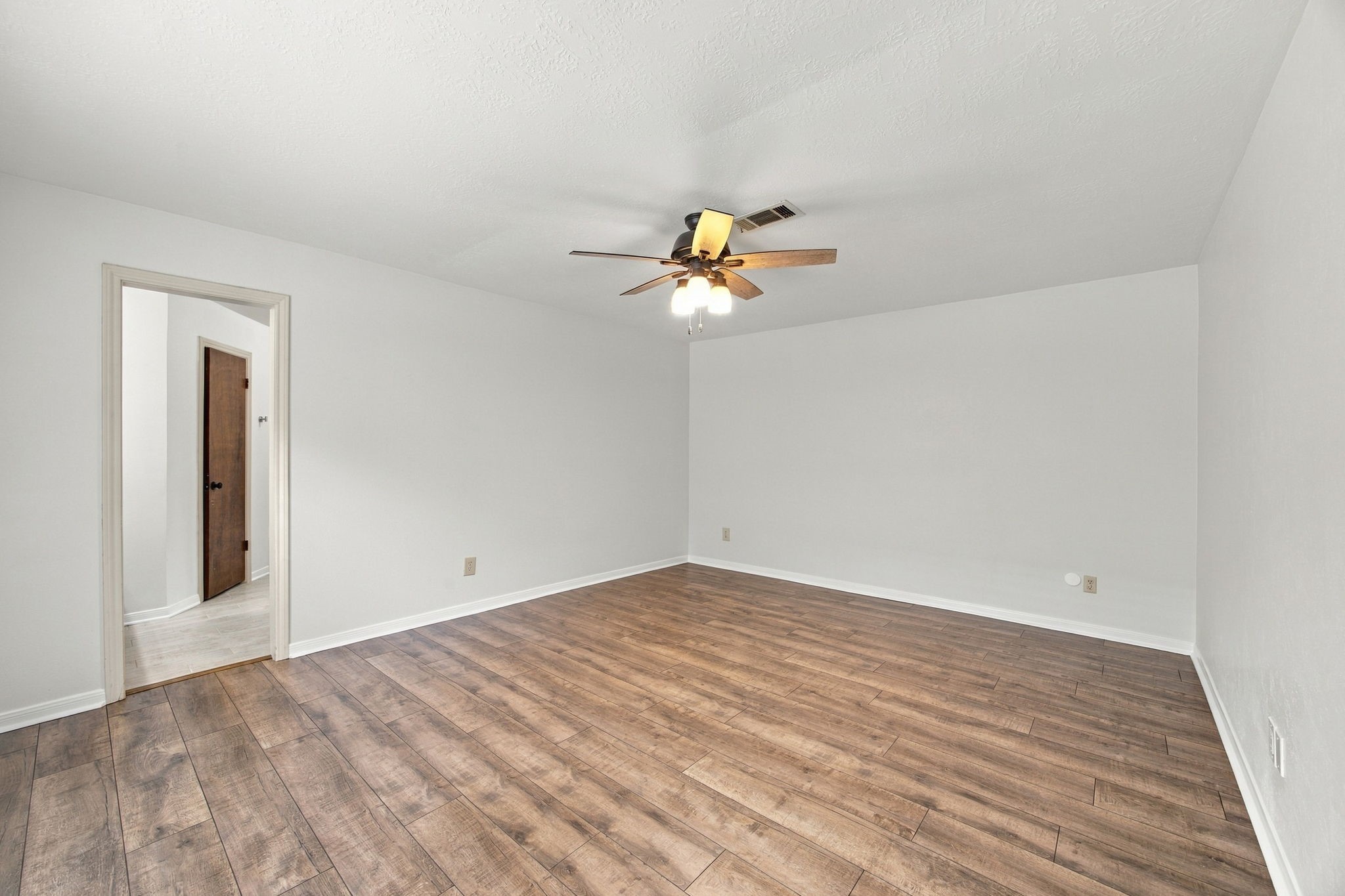 The primary bedroom is a good size. New flooring and no carpet for easy maintenance.