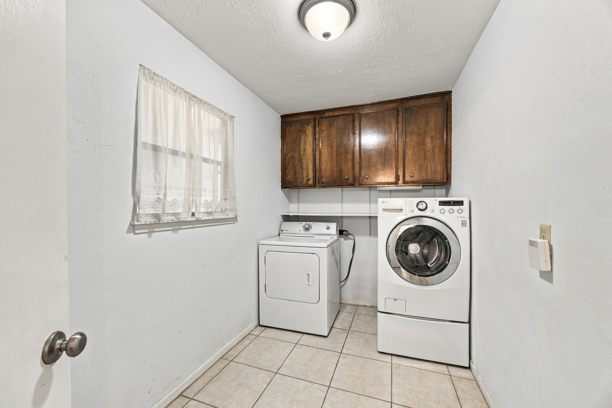 The laundry room in the back of the home. It is a large space and could be great storage.