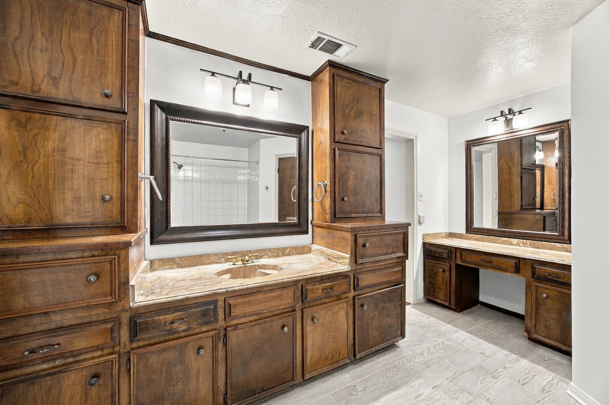 Primary bathroom has more cabinets than some kitchens...  Plenty of room for everyone to get ready in the morning.