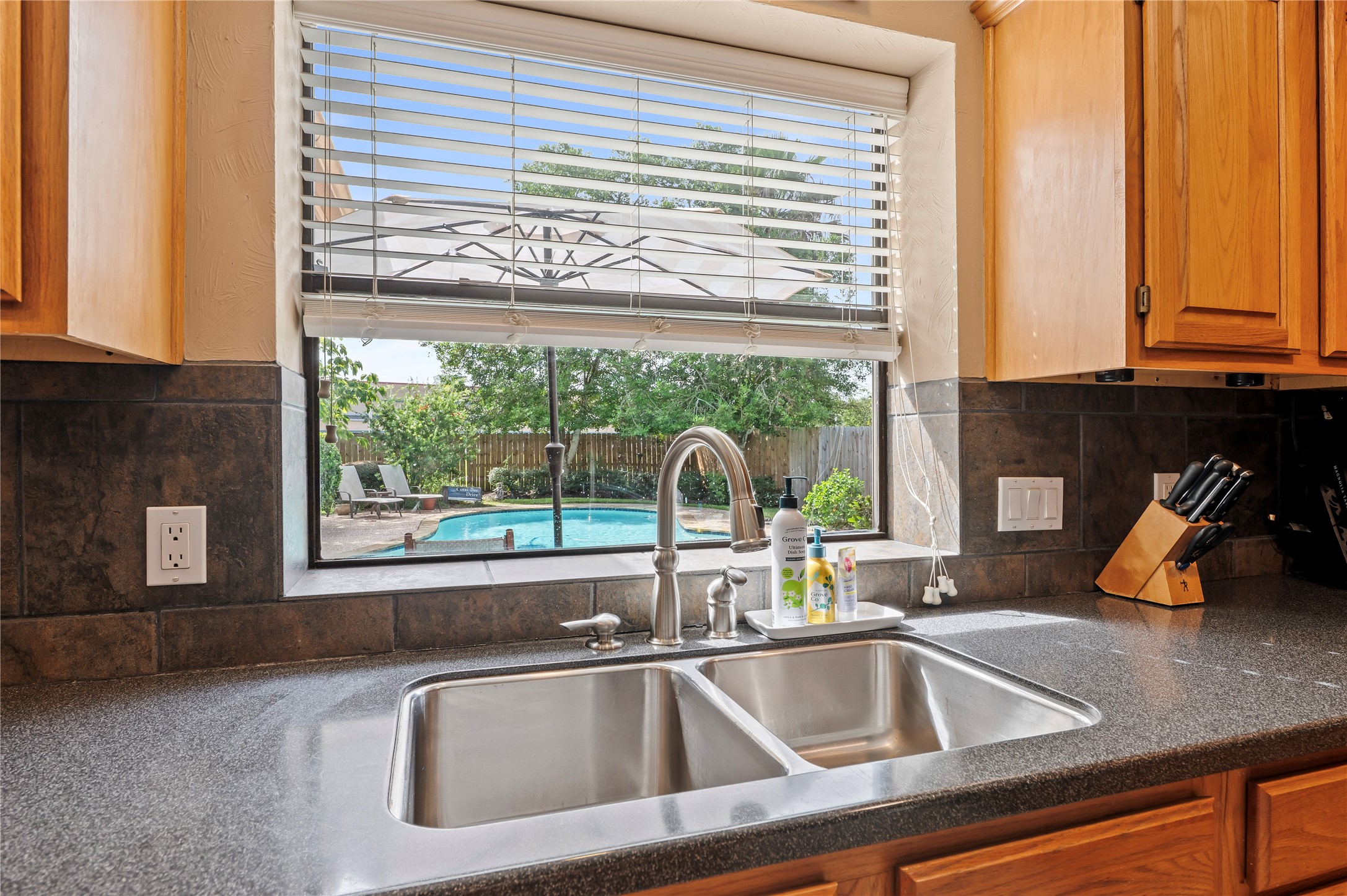 Taking care of dishes while planning for the next pool party.