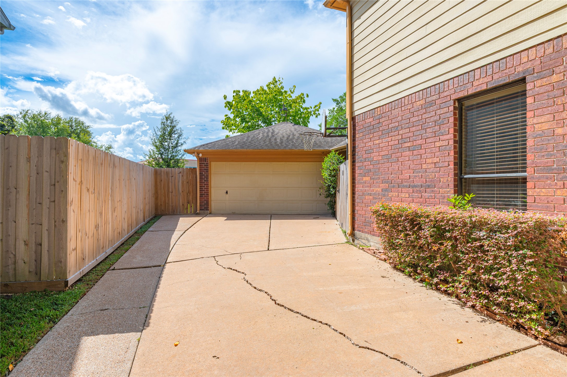 The driveway leads back to a detached two-car garage.