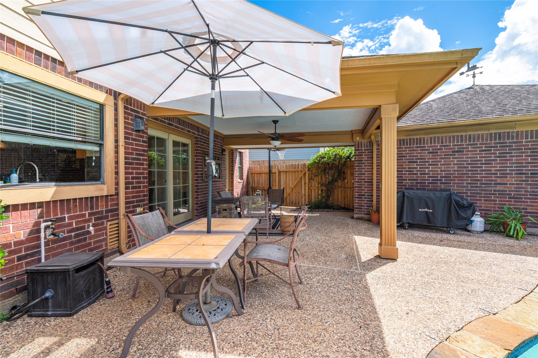 An open patio area alongside the house for outdoor dining in the sunshine.